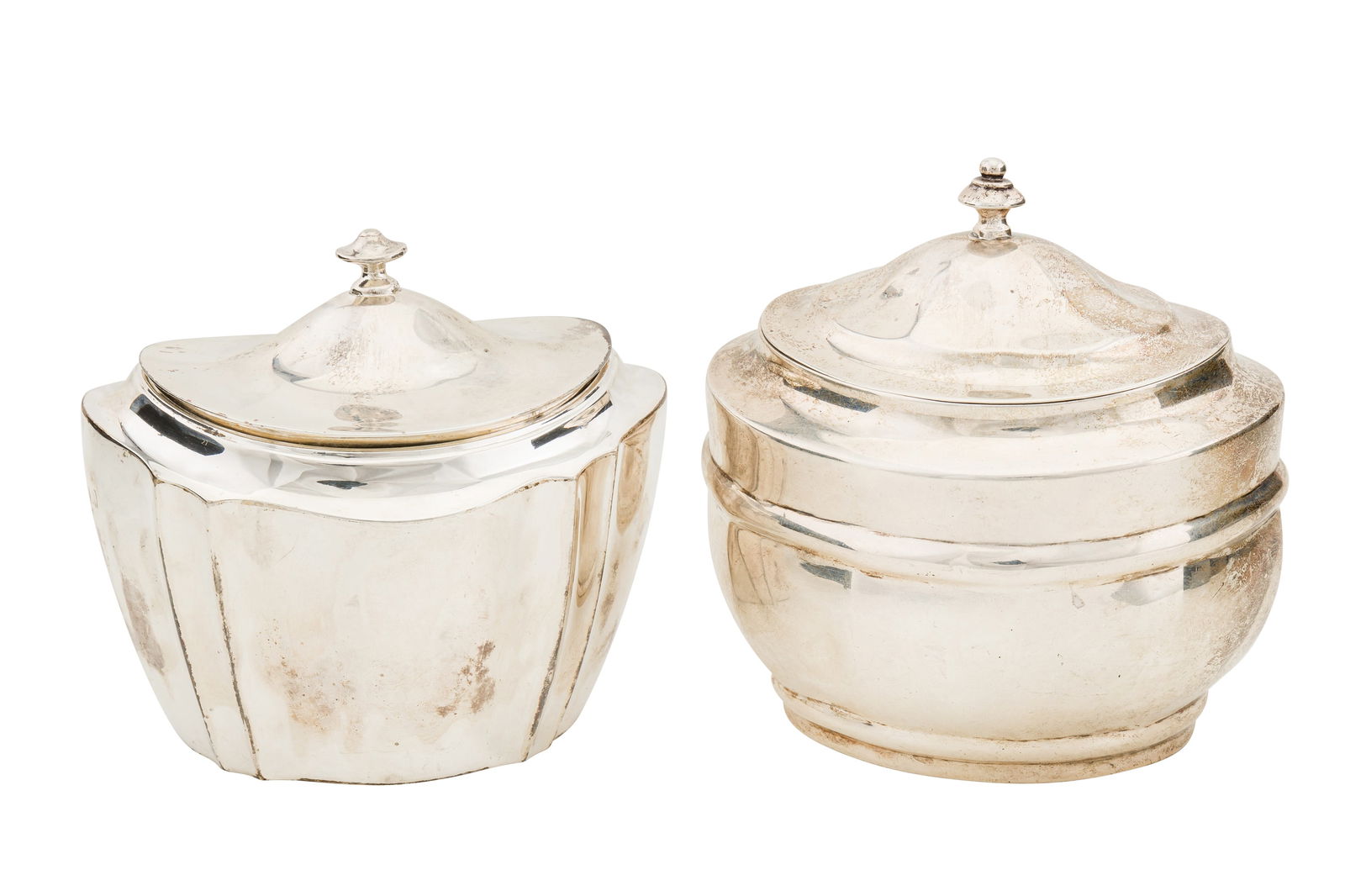 A Victorian sterling silver tea caddy, London 1898 by Charles Stuart Harris: A Victorian sterling silver tea caddy, London 1898 by Charles Stuart Harris Oval form with a hinged lid, together with another similar example 1899 by the same maker, shaped form. (2) Length – 9
