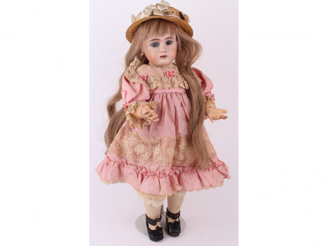 A Jumeau bisque head child doll, French circa 1900: A Jumeau bisque head child doll, French circa 1900, having open mouth, four upper teeth, blue glass sleep eyes, and pierced ears with coral style earrings, long blonde real hair wig, cork pate, on a w