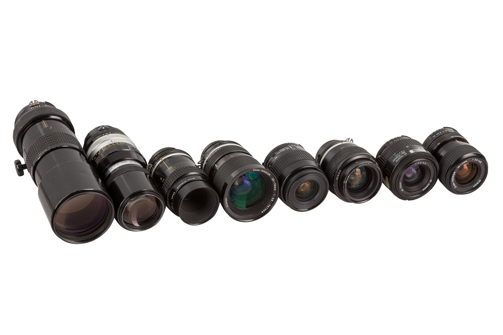 A Selection of Nikon SLR Lenses: A Selection of Nikon SLR Lenses including a 300mm f/4.5 (532526), a 20cm f/4 Nikkor-Q (206743), a 55mm f/2.8 Micro-Nikkor (262437) and five Zoom-Nikkor lenses with focal lengths between 28-80mm