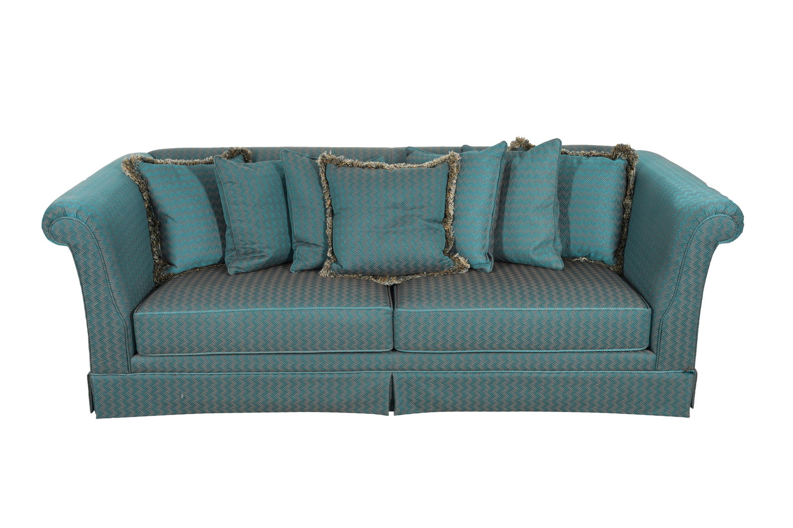 JOHN HUTTON INTERNATIONAL: JOHN HUTTON INTERNATIONAL, a sofa featuring rolled arms and a sleek tailored skirt, upholstered in vibrant teal fabric with intricate geometric pattern, complemented by matching scatter cushions trimm