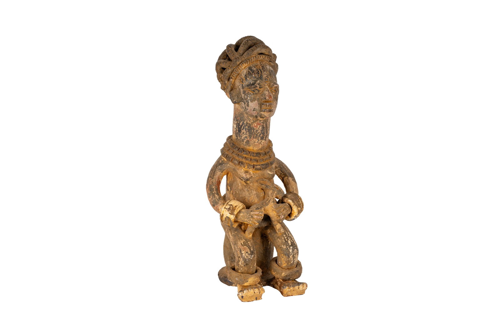 A NIGERIAN TERRACOTTA FIGURE: A NIGERIAN TERRACOTTA FIGURE, possibly Yoruba, the seated female figure modelled with elongated neck and stylised coiffure, adorned with necklace and anklet details. Height: 36cm high