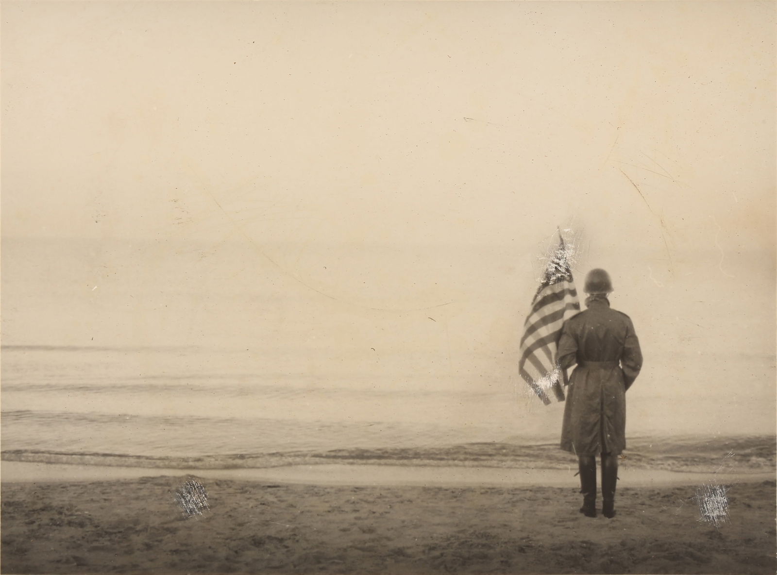 Robert Capa (1913-1954): Robert Capa (1913-1954) NORMANDY, 1944. Rare vintage silver gelatin press print, image size 14.8 x 20cm, sheet size 16 x 21cm, original typed caption affixed to print verso and with photographer's sta