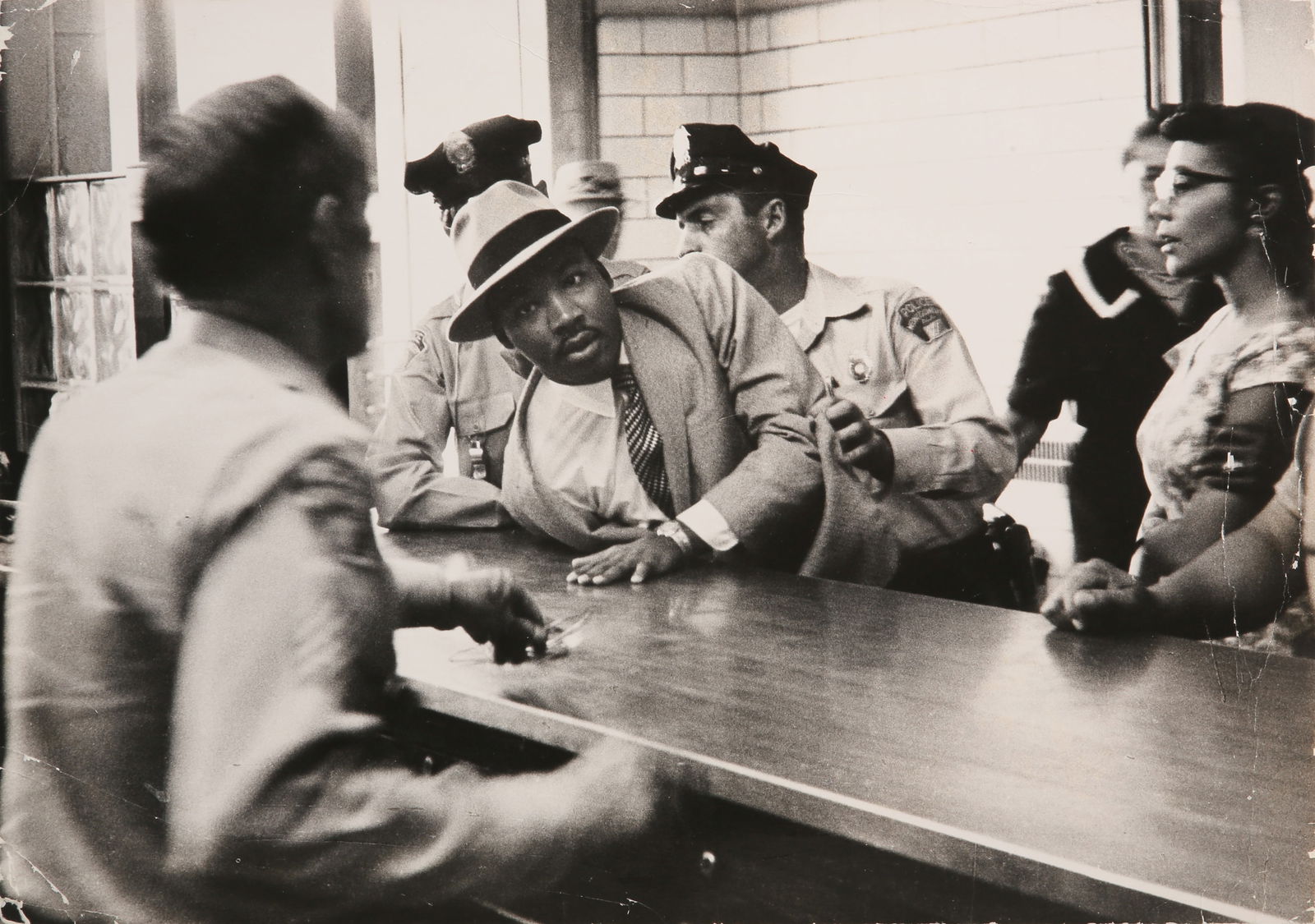 Charles Moore (1931-2010): Charles Moore (1931-2010) ARREST OF MARTIN LUTHER KING, JR., BIRMINGHAM, ALABAMA, 3 SEPTEMBER 1958. Vintage silver gelatin print, image/sheet size 25 x 34.6cm, signed, dated and annotated 'Vintage' by