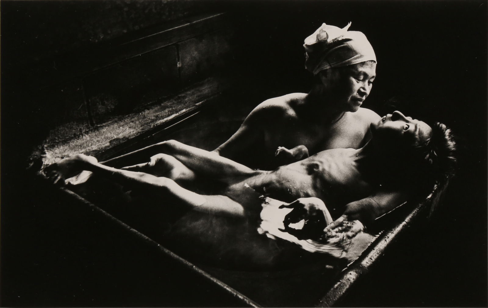 W. Eugene Smith (1918-1978): W. Eugene Smith (1918-1978) TOMOKO AND MOTHER IN THE BATH, MINAMATA, 1971. Silver gelatin print, printed c.1985, image size 13.5 x 21.3cm, caption, including Magnum distribution credit, typed directly