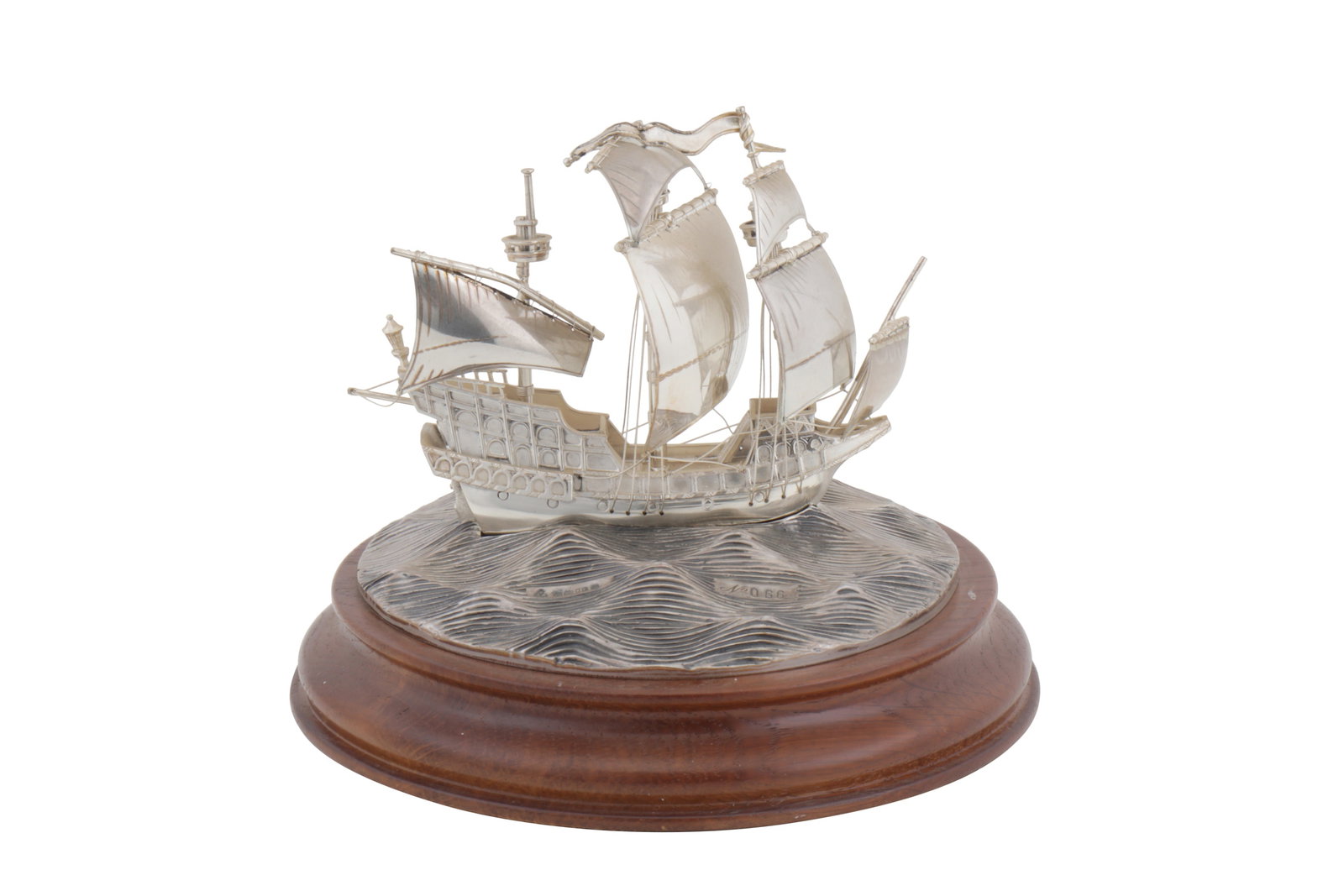 An Elizabeth II sterling silver model of the Golden Hind ship: An Elizabeth II sterling silver model of the Golden Hind ship Wooden base, number 66. Diameter – 15 cm / 5.9 inches