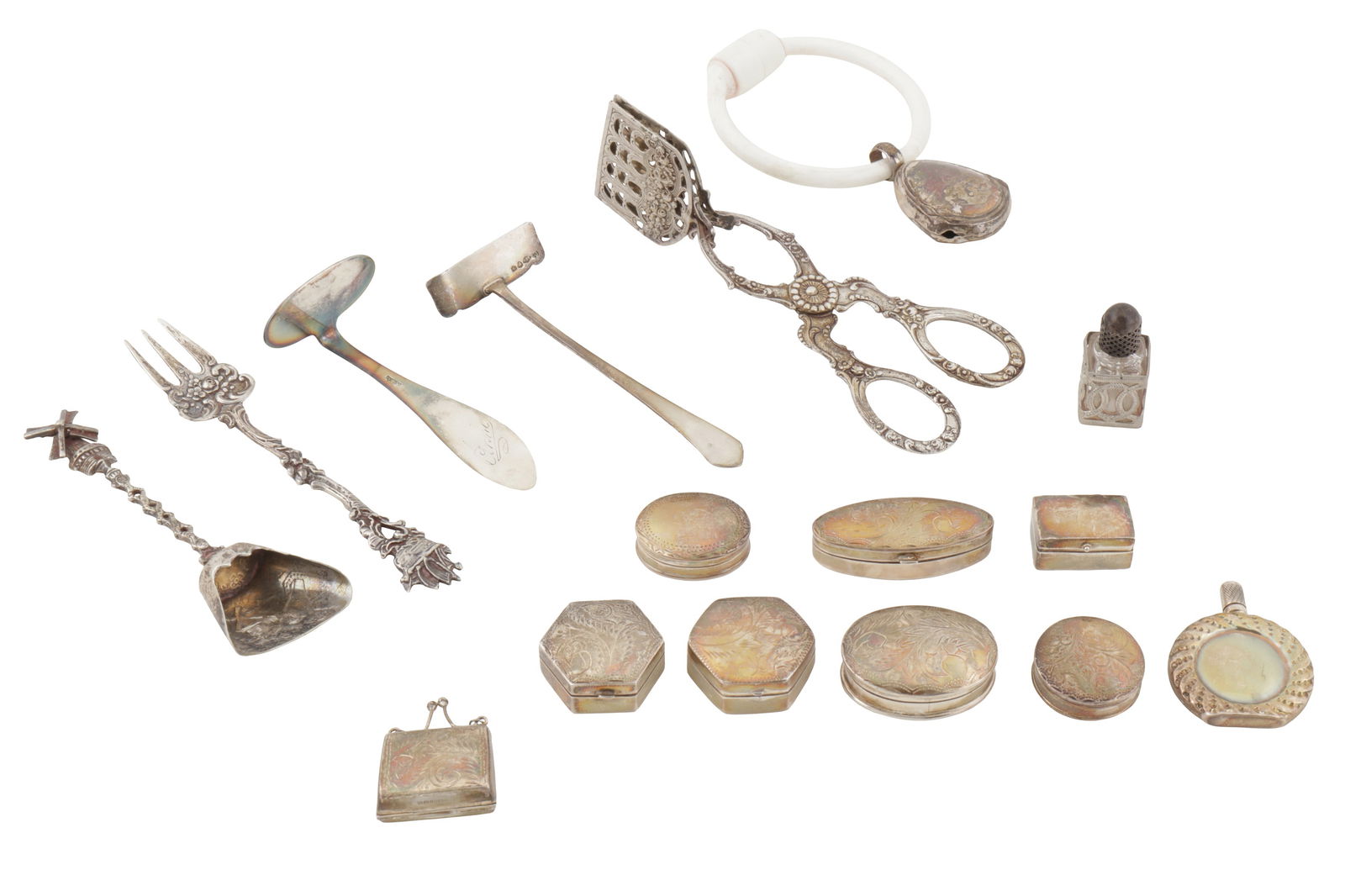 A mixed group of modern sterling silver pill boxes: A mixed group of modern sterling silver pill boxes Various shapes and decoration. Together with a baby’s rattle, scent bottle, a selection of 800 standard silver flatware and a silver plated pus