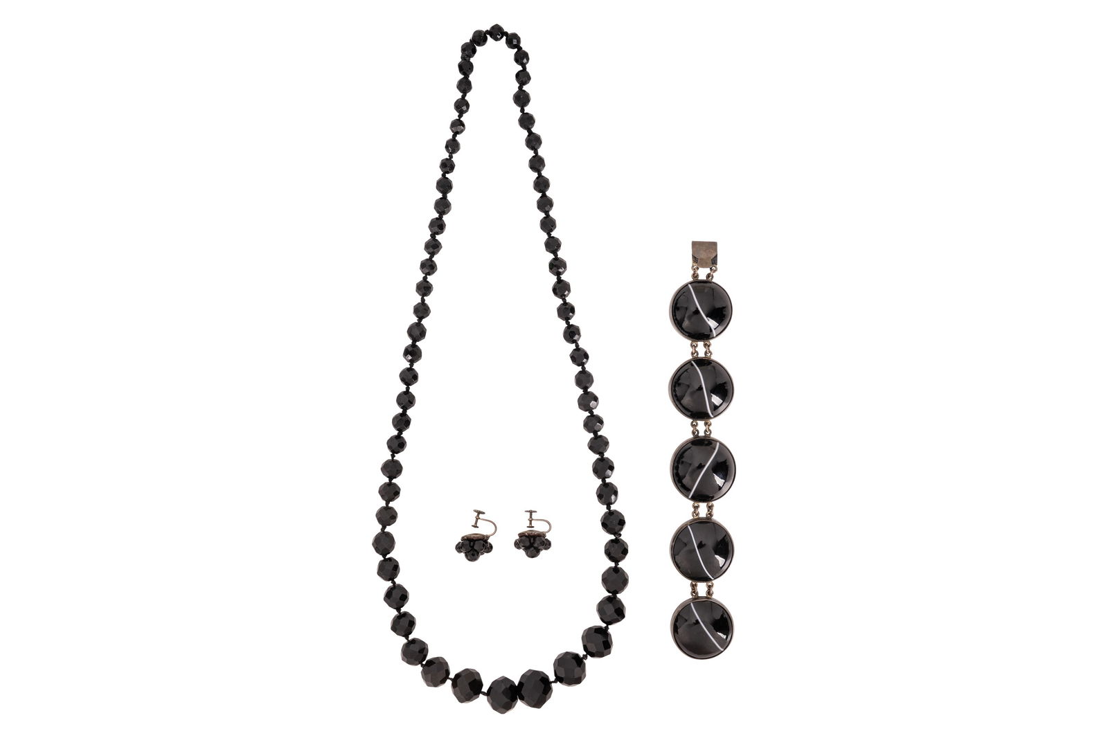 A GROUP OF JET AND BANDED AGATE JEWELLERY: A GROUP OF JET AND BANDED AGATE JEWELLERY, To include a graduated bead jet necklace and bead screw-back earrings, together with a circular-cut cabochon banded agate bracelet, set in white metal, earri