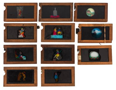 Mahogany Framed Magic Lantern Slipper Slides: Mahogany Framed Magic Lantern Slipper Slides A SELECTION OF MAHOGANY FRAMED HAND PAINTED SLIPPER SLIDES, 11 in total, including a gentlemen loosing his hat in the wind, 'a Zulu Fix', a Cherub, a man d