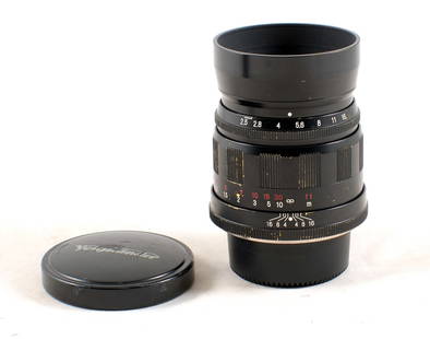 L39 Screw Mount Voigtlander 75mm f2.5 MC Color-Heliar Lens.: L39 Screw Mount Voigtlander 75mm f2.5 MC Color-Heliar Lens. #9020121. Signs of heavy use, with large cloudy patch to inside element. With caps and hood.