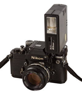 A Nikon F2 Photomic SLR Camera: A Nikon F2 Photomic SLR Camera Serial No: 7925151 Body: VG Shutter: working Lens: Nikon 50mm f/1.4 Nikkor (3811006) Notes: with maker's strap and SB-7E flash unit