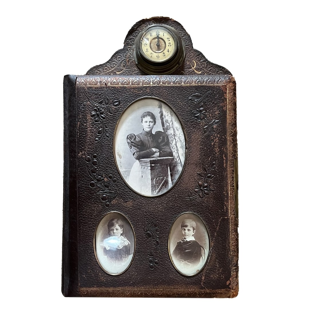 Victorian Photograph Album with Intergral Clock.: Album size approx 9 /2" x 12" with 32 pages for cabinet cards and CDVs. Alternate pages feature a floral design. Lock missing one support post. Clock not functoning, possibly overwound.