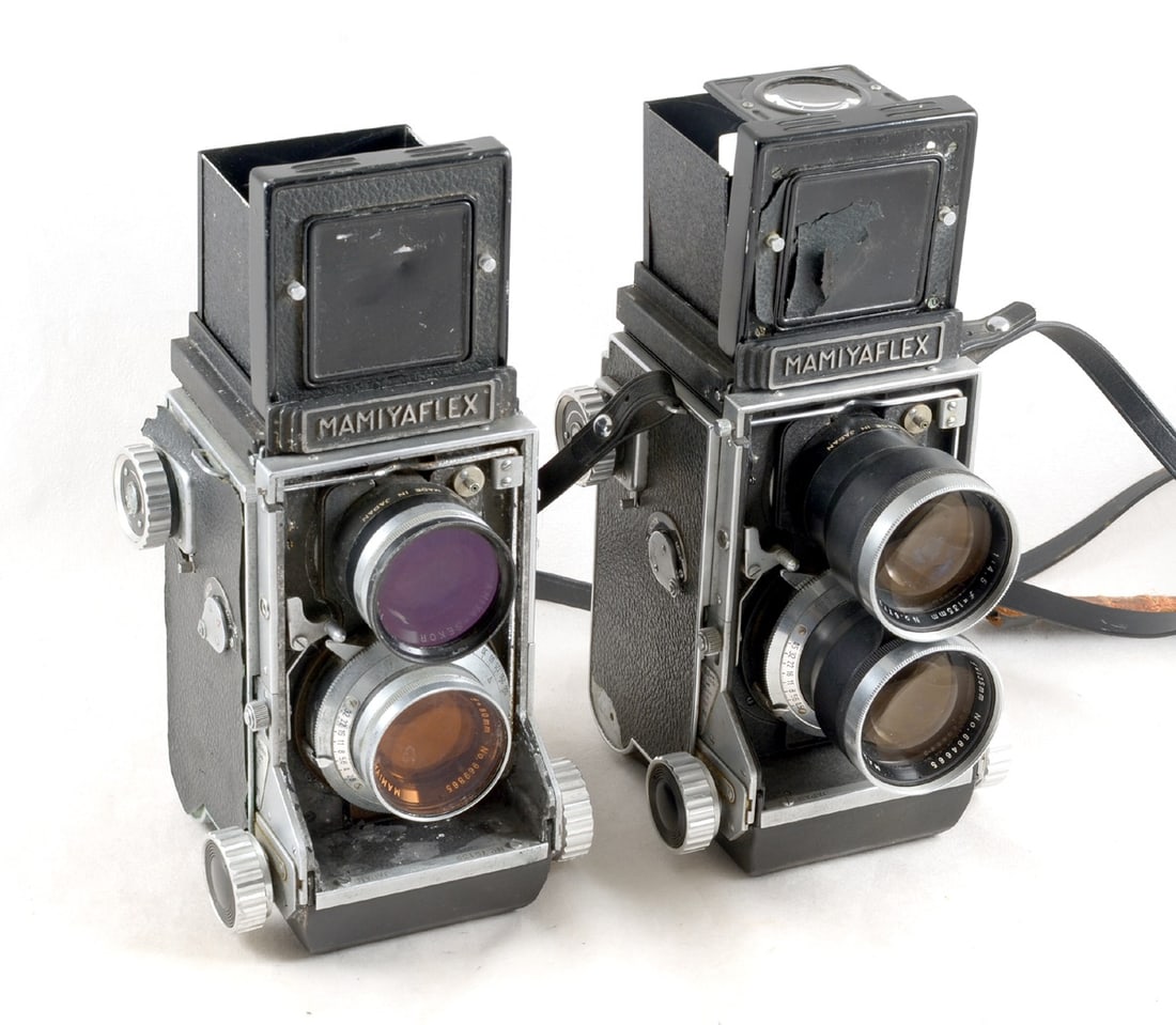 Mamiyaflex TLR Camera with 135mm Portrait Lens.: Mamiyaflex body (signs of heavy use) leatherette covering missing from top of viewing hood & bottom of one side. With an interchangeable 135mm f3.5 lens (shutter firing, taking lens very slight haze).