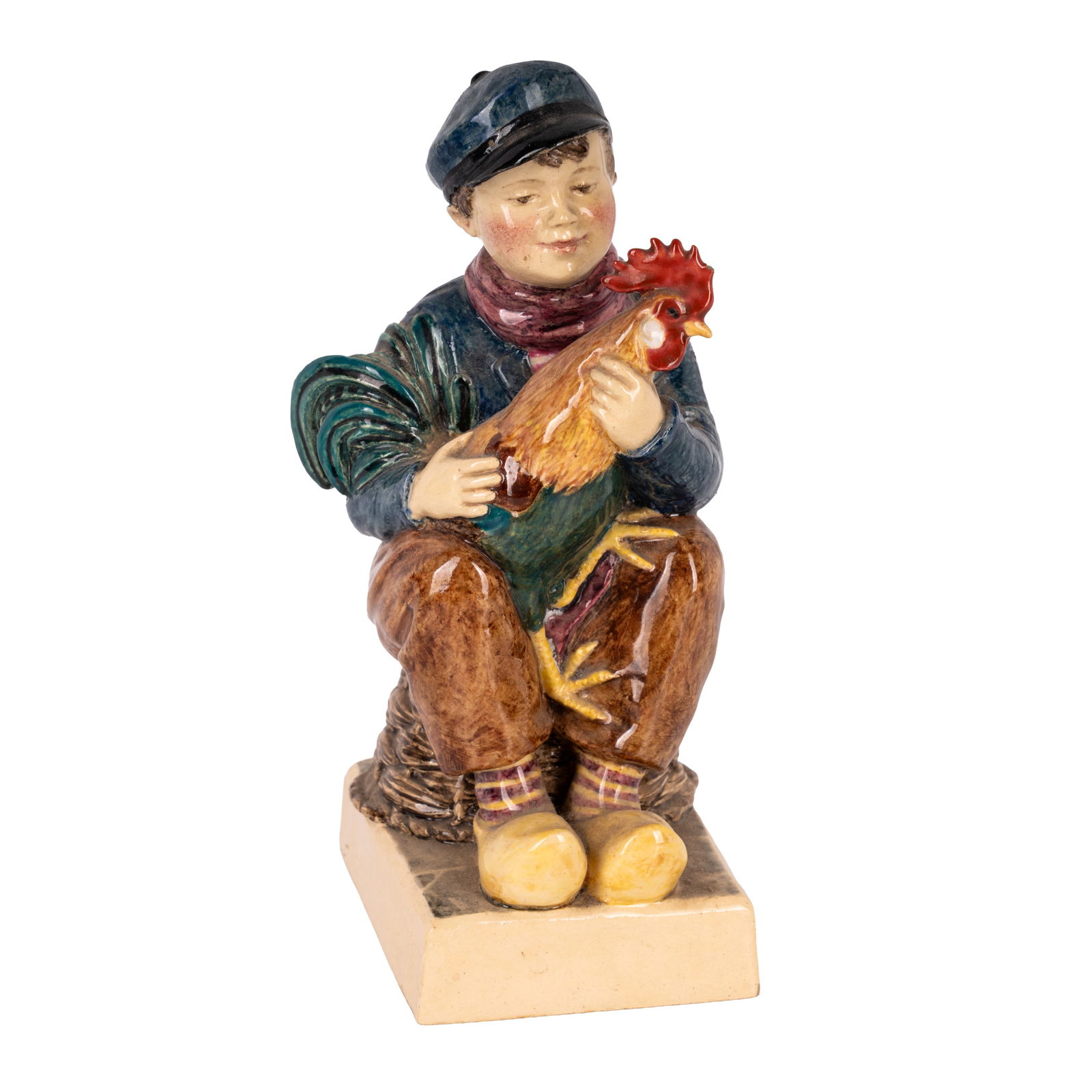 Jessamine S Bray and Sybil V Williams for Dulwich Pottery (British) Model of a dutch boy holding: Circa 1930 Painted and glazed earthenware Handpainted to underside 'DULWICH / JSB / V / W / 1933 / ENG', and to the back of the integral plinth base 'JSB / V / W' 15.5cm high Notes: Jessamine S Bray a