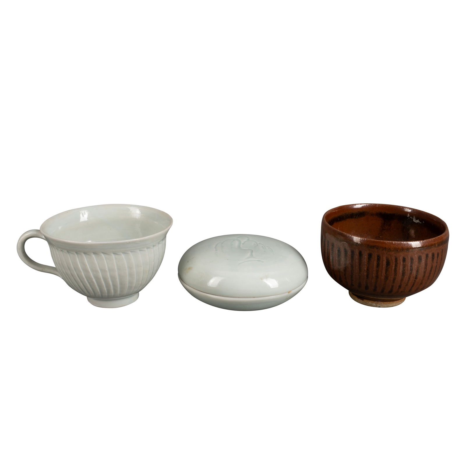 David Leach (British 1911-2005) for Lowerdown Pottery Group of three studio pottery items: A tenmoku glazed cut sided footed bowl stamped for Lowerdown, 6.5cm high, a celadon glazed pot and cover decorated with willow tree decoration stamped for David Leach, 10.5cm diameter, and a similar c