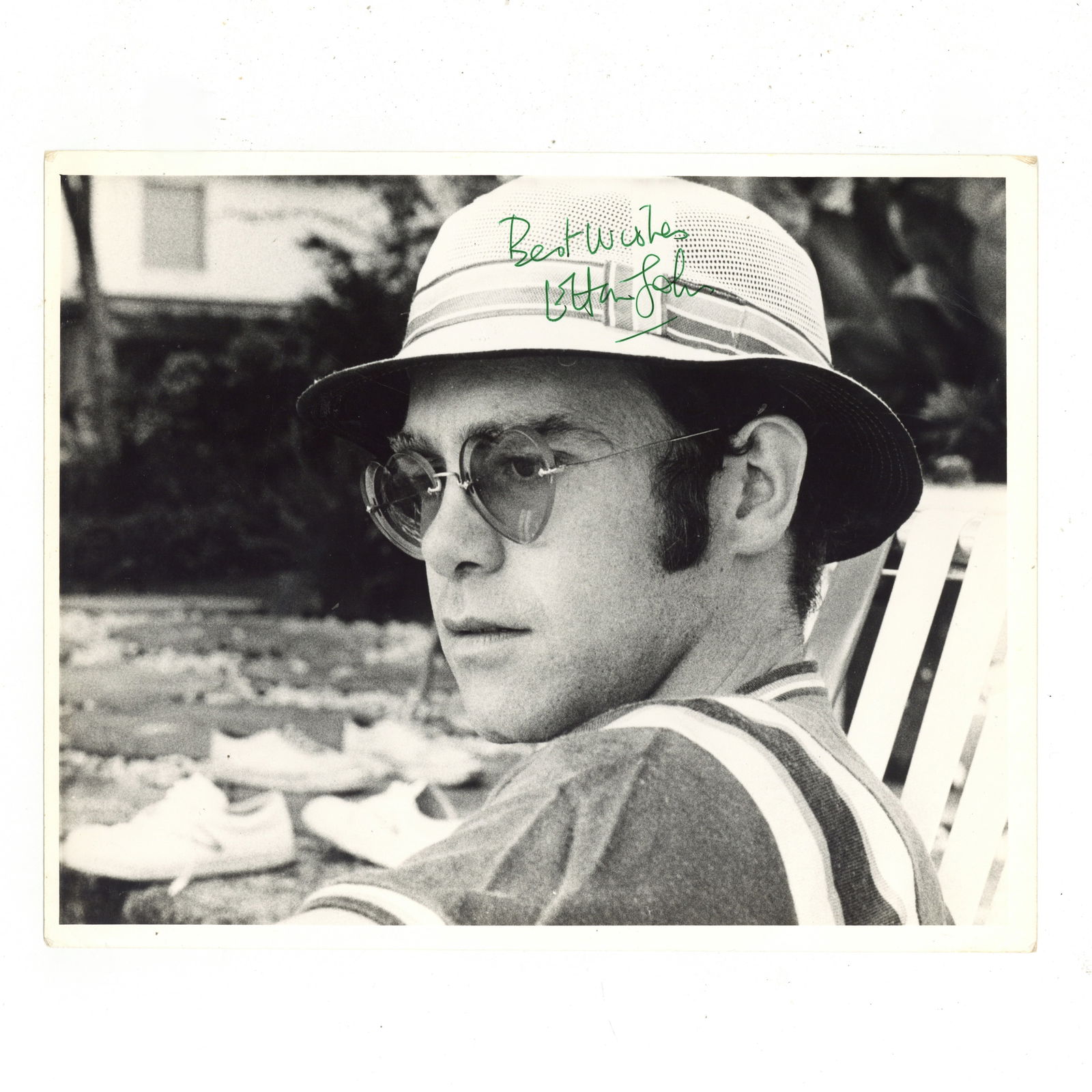 John (Elton) Signed photograph: John (Elton) Signed photograph Glossy black and white photograph of a young John Lennon in a head and shoulders pose, signed in green ink near the top margin, handling wear and creasing to margins