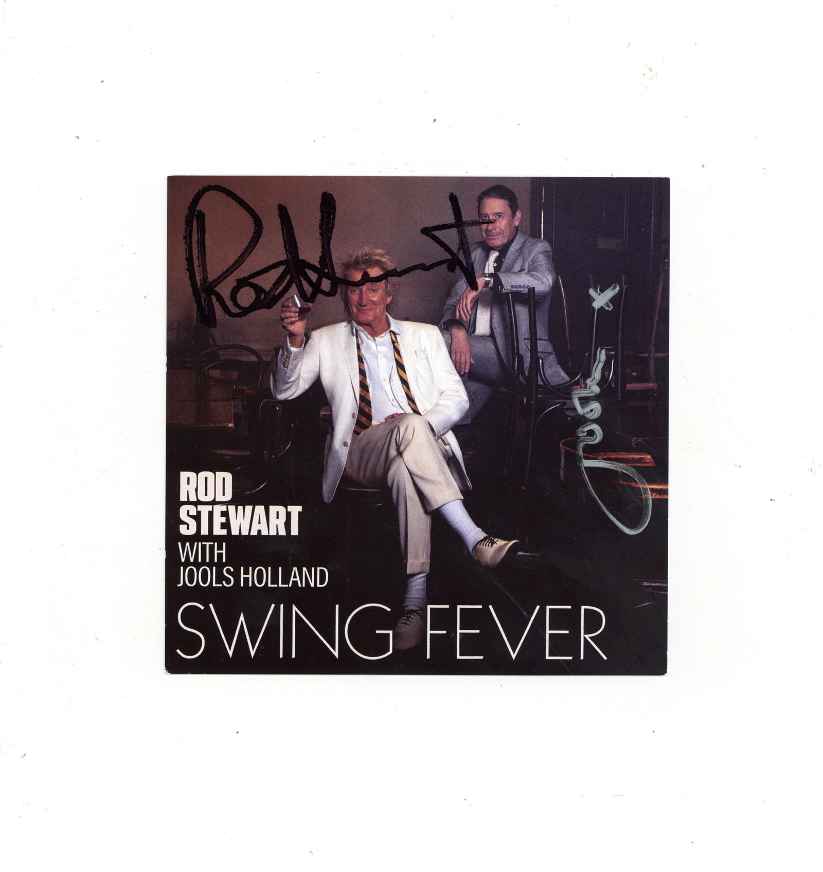 Stewart (Rod ) & Jools Holland Signed CD insert card: Stewart (Rod ) & Jools Holland Signed CD insert card Colour cd-sized art card originally included in the vinyl limited edition album 'Swinging Fever' , signed by Rod Stewart and Jools Holland, light