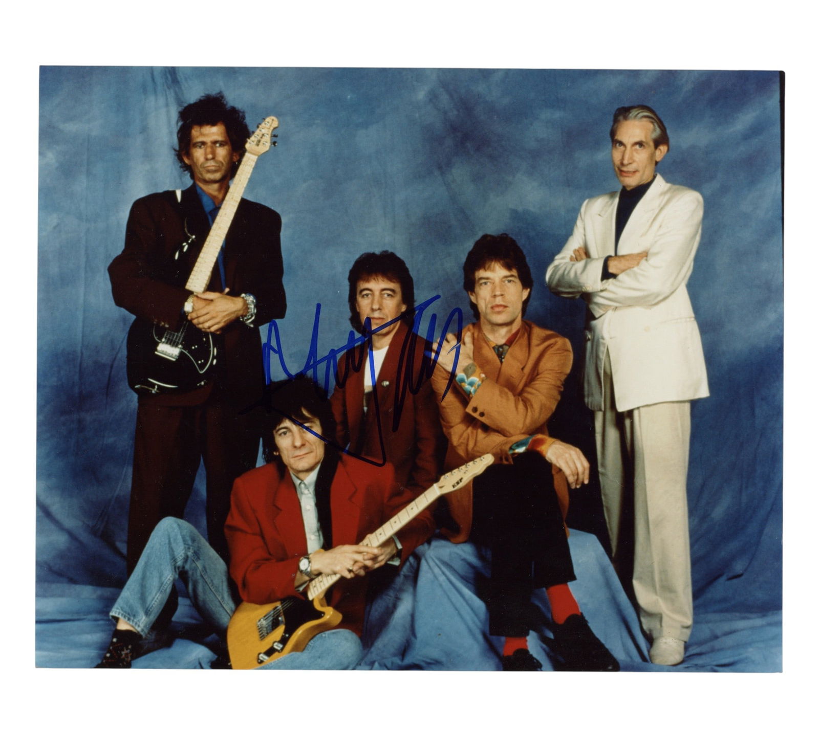 Jagger (Mick) Signed photograph: Jagger (Mick) Signed photograph Glossy colour photograph of the Rolling Stones, c. 1995, signed in blue felt tip by Mick Jagger across the image. ***The signature has been pre-verified by Roger