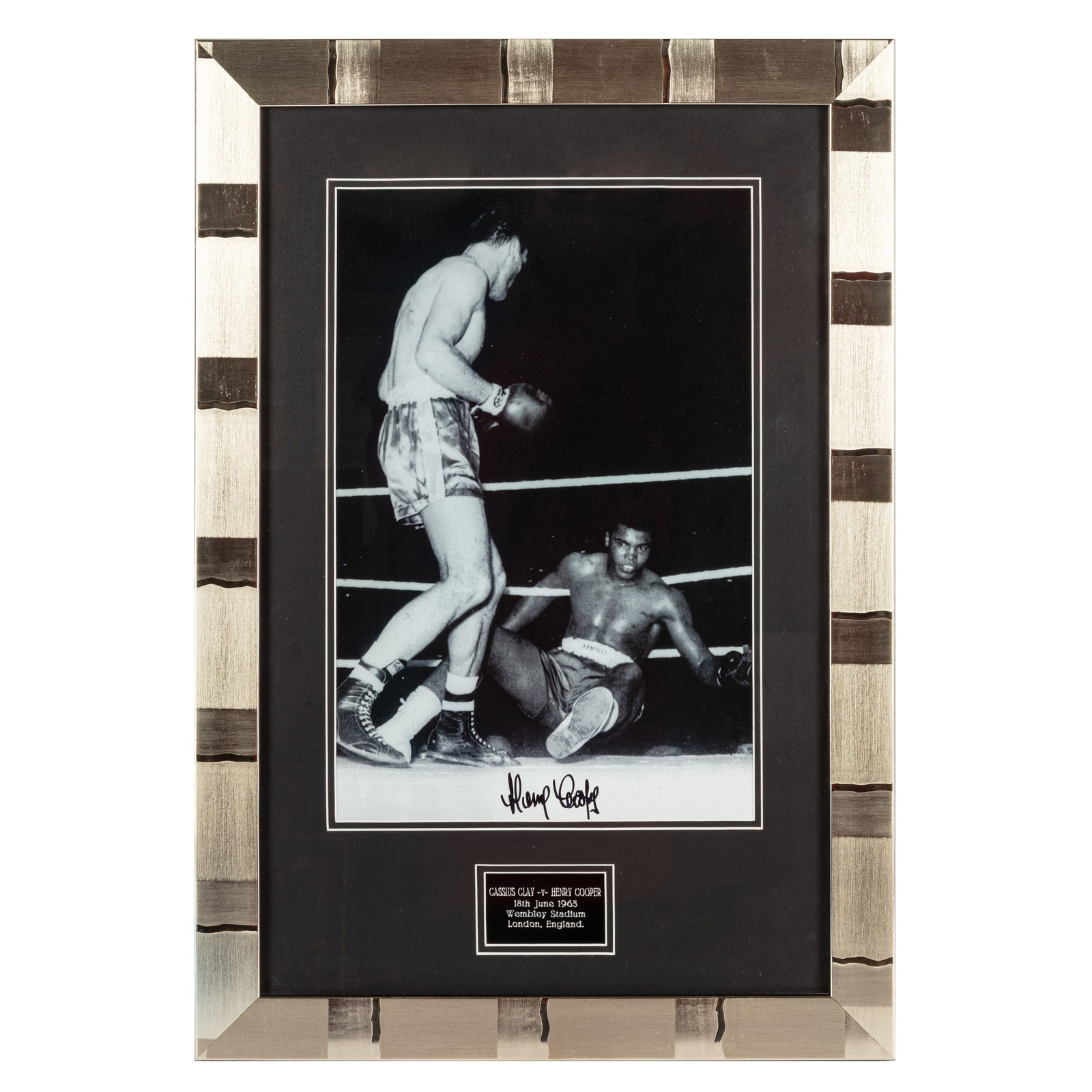 Cooper (Henry) Signed photograph: Cooper (Henry) Signed photograph Large black and white photograph of Cooper after knocking down Muhammad Ali at Wembley Stadium, 1963, signed by Cooper in black ink, mounted for display.