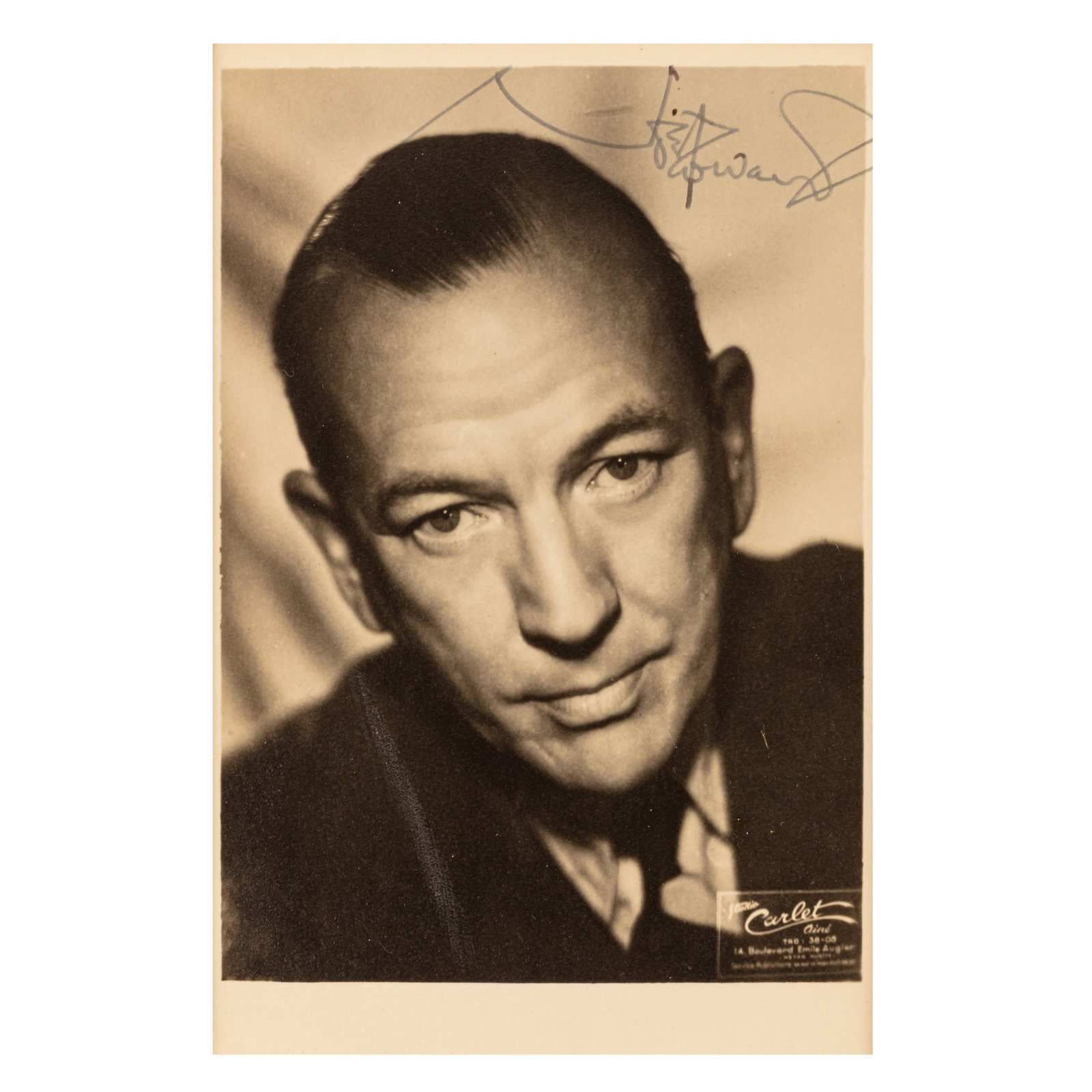 Coward (Noel) Signed photograph: Coward (Noel) Signed photograph Vintage black and white studio portrait of Noel Coward in a head and shoulders pose, signed in ink along the upper margin, mounted for display, some handling wear. Dim