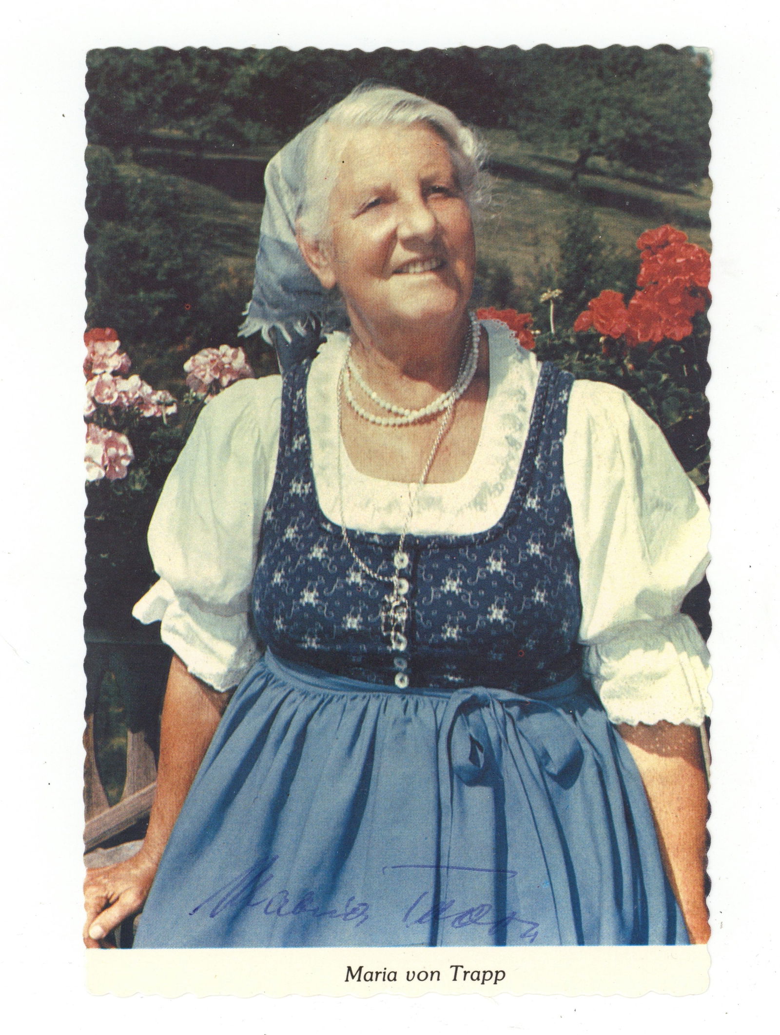 Von Trapp (Maria) Vintage signed colour postcard photo of Maria Von Trapp: Von Trapp (Maria) Vintage signed colour postcard photo of Maria Von Trapp signed on the front in blue ballpoint, "Maria Trapp," and on the reverse as well, in very good condition. Dimensions:6 x 4"