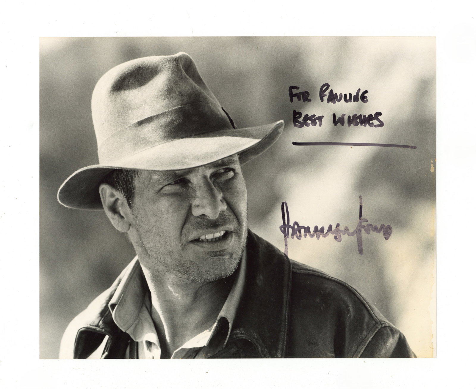 Ford (Harrison) Signed photograph: Ford (Harrison) Signed photograph Black and white photograph of Harrison Ford as Indiana Jones, signed and inscribed in black felt tip "For Pauline, Best wishes, Harrison Ford", some discolouration