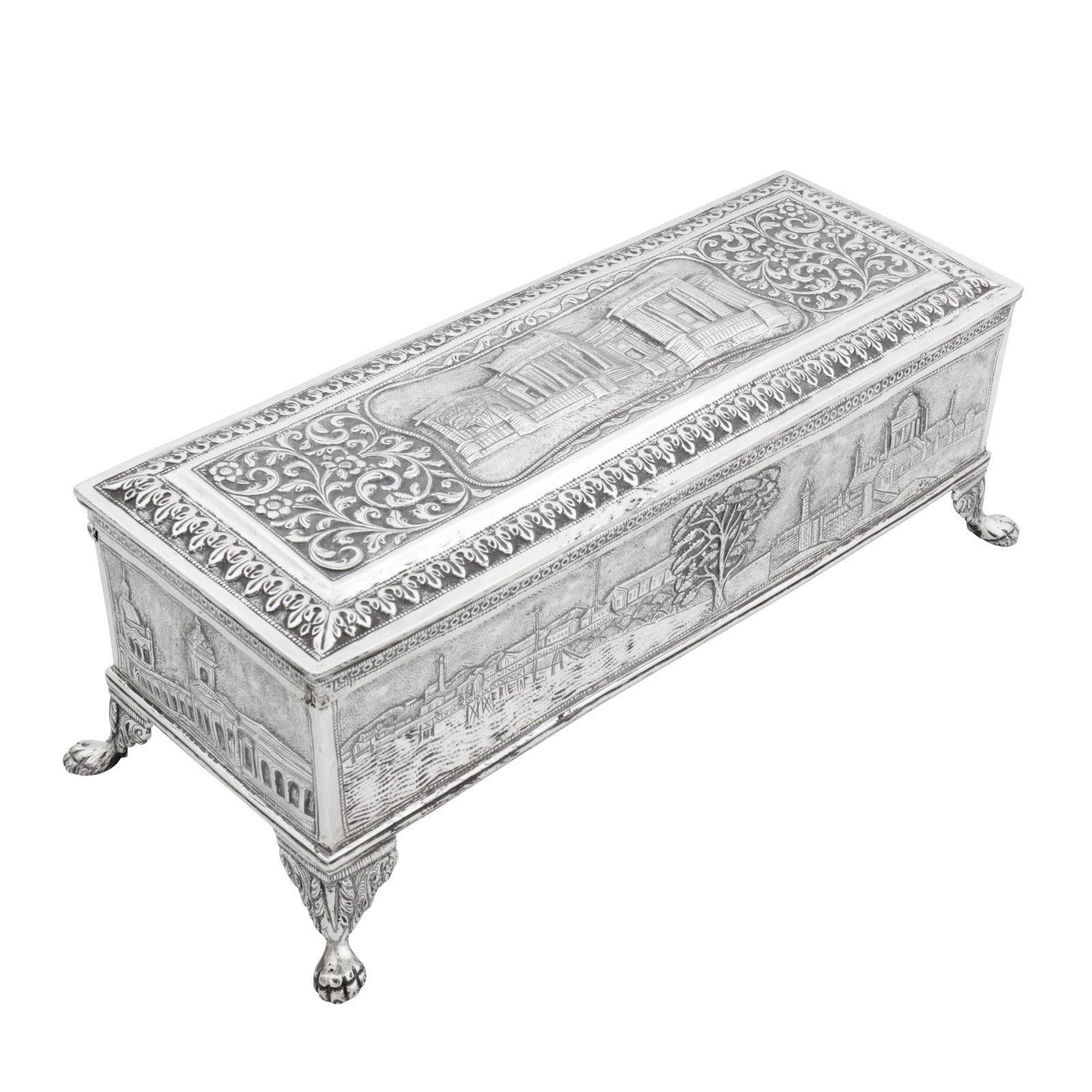 Karachi circa 1920 An early 20th century Anglo – Indian silver casket: Raj period. Of rectangular form with a hinged lid upon four claw and ball bracket feet. The lid with an embossed central scene of Imperial Bank of India, Karachi, reserved with Cutch type foliate scro