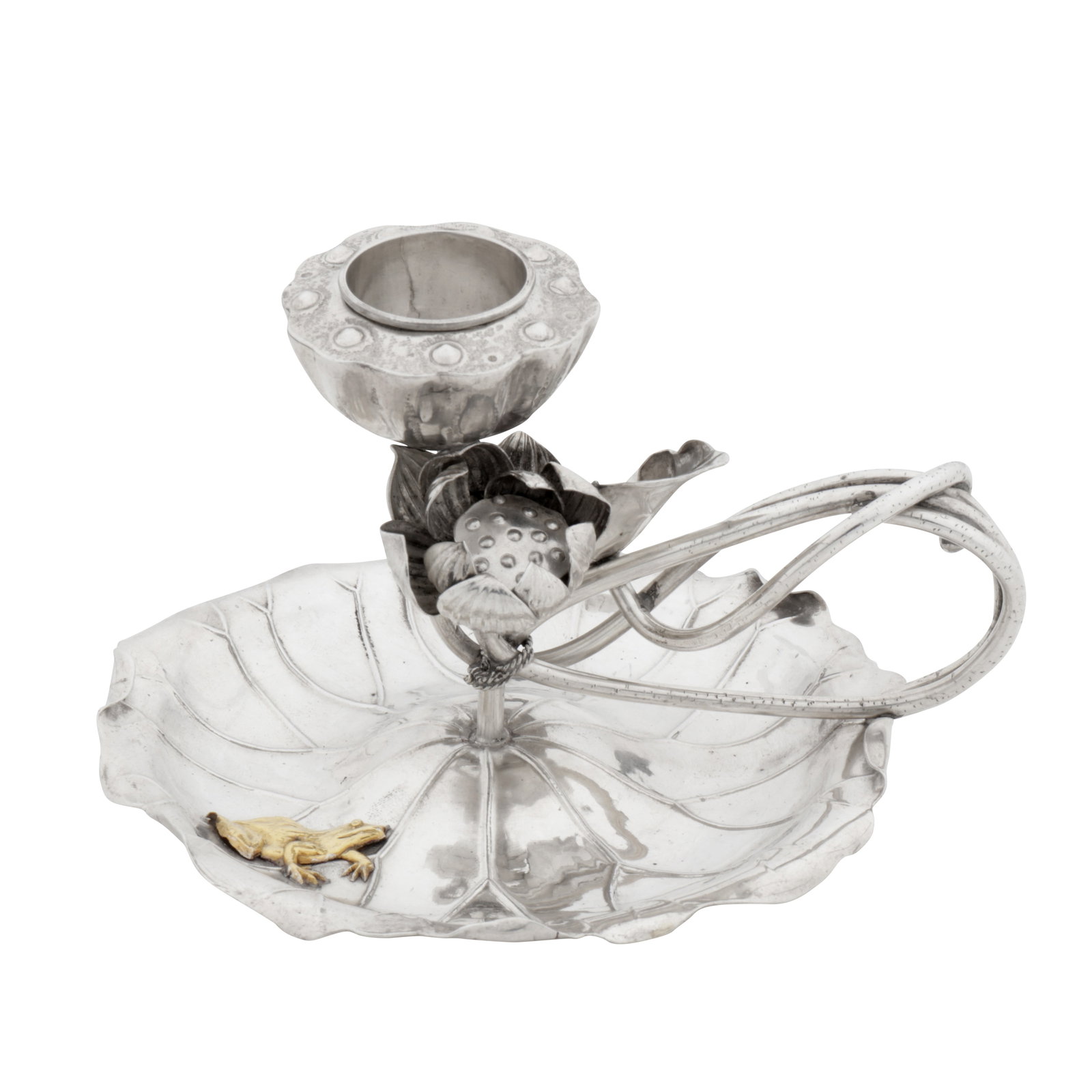 Yokohama circa 1910 An early 20th century Japanese silver chamberstick: Meiji period. Formed as a water lily with them stem forming an interwoven hammer, the lily pad base with an applied yellow metal frog. Marked underneath jungin standard mark. Length – 13.2 cm / 5.2