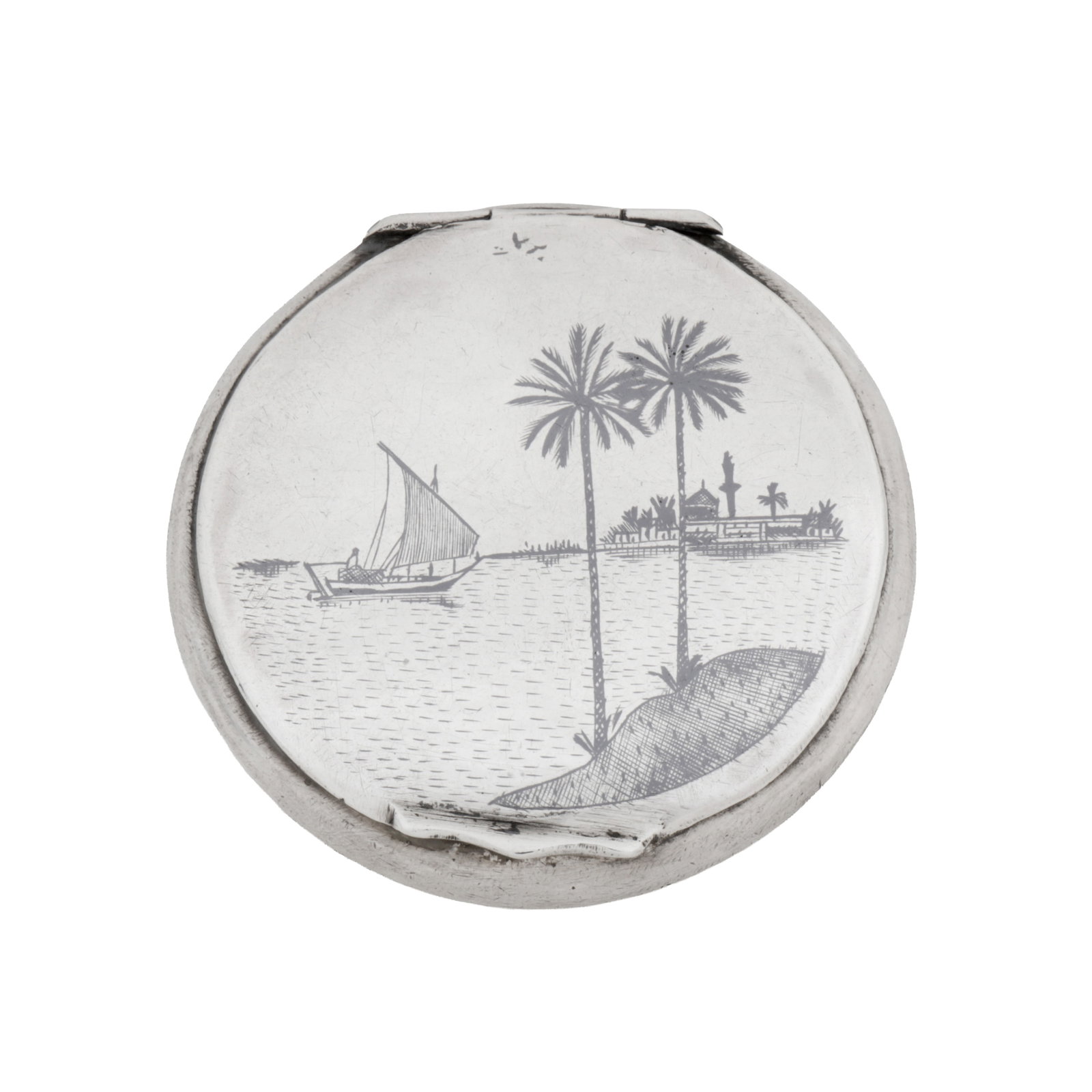 Omara dated 1952 A mid-20th century Iraqi silver and niello silver compact: Of circular form, niello decoration to the lid and a dhow sailing boat to the reverse. Mirror to interior. Engraved S.S Kenya Castle 25. 12.52. Signed to the front. Diameter – 6.8 cm / 2.65 inches