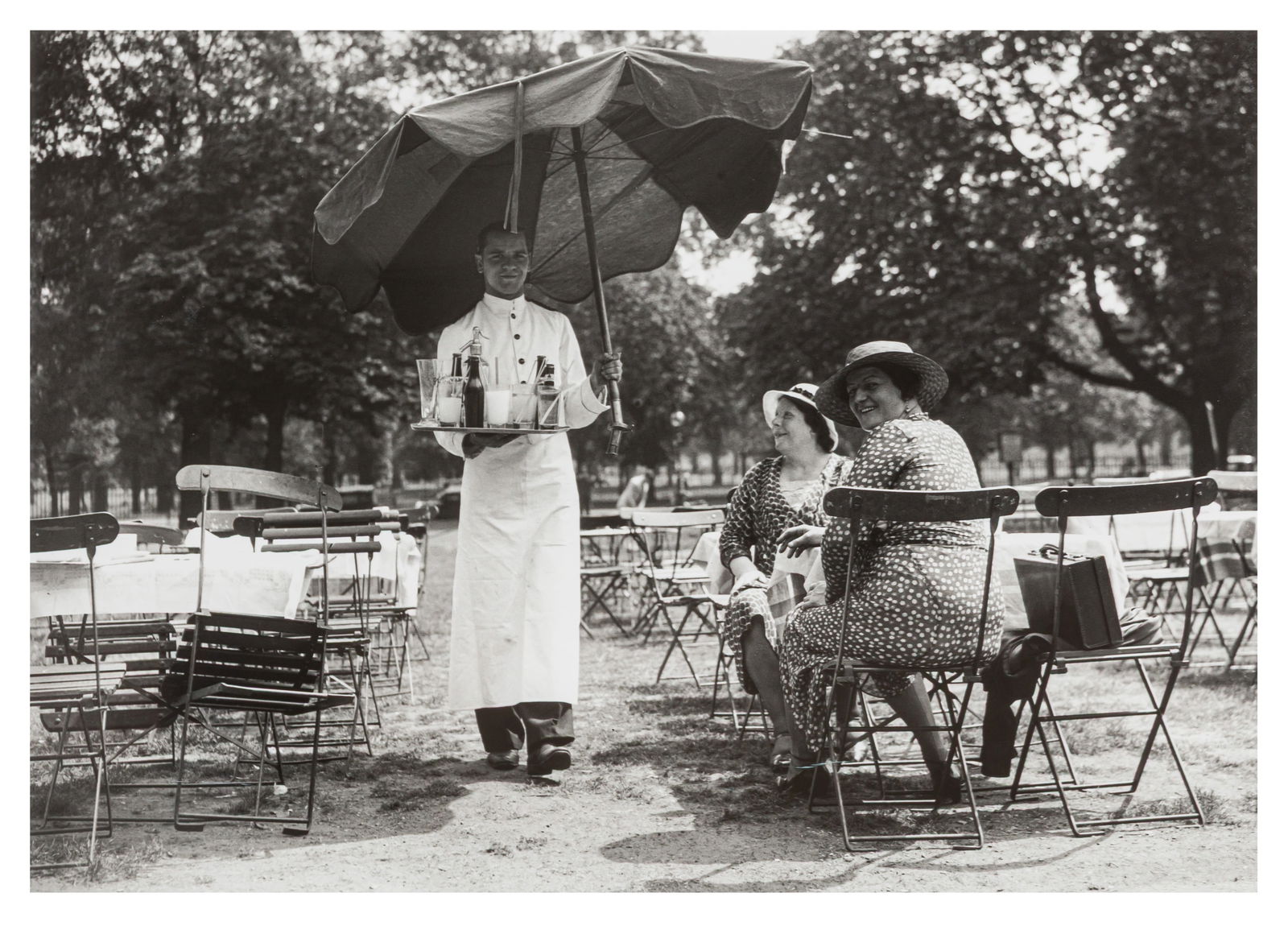 KENSINGTON GARDENS, LONDON, 1935: KENSINGTON GARDENS, LONDON, 1935 IN THE SHADE, LONDON, KENSINGTON GARDENS, 14TH JULY 1935. A pair of silver gelatin prints, printed later by Getty Images Gallery, from the Topical Press Agency Collec