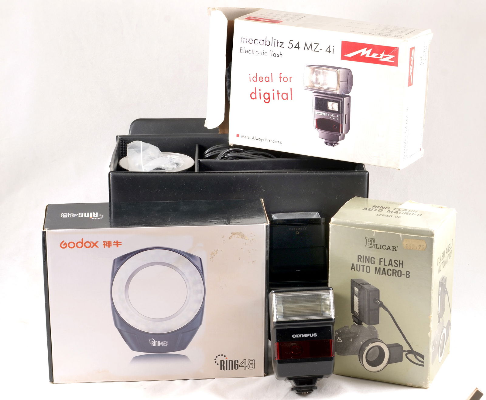A Group of Flash Units. RingFlash, Macro Flash, Metz.: A Group of Flash Units. RingFlash, Macro Flash, Metz. To include Godox and two other ring flash units for macro photography, Metz MZ 54 Zi etc. All in working order with signs of normal use only.