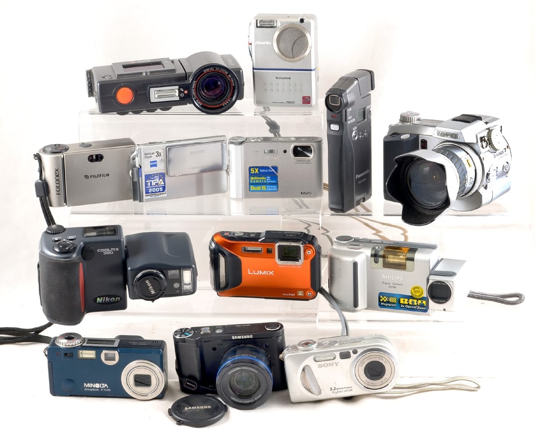 A Group of Digital Cameras. Some with a battery, others for AA or AAA batteries. (1 of 3)