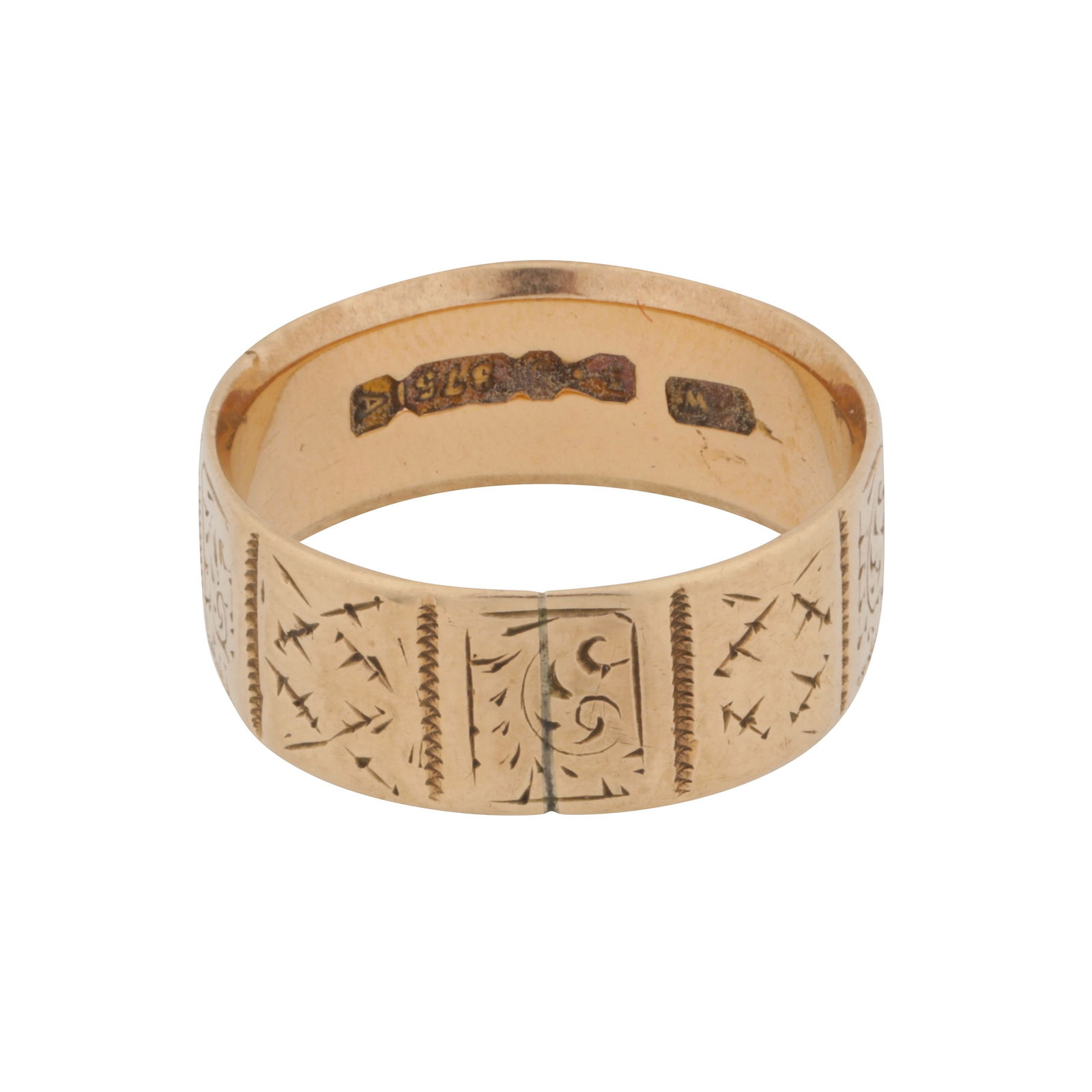 A cigar band ring 9ct yellow gold: A cigar band ring 9ct yellow gold The 7.3mm wide band, of flat-edged design, each panel engraved with geometric and scroll motifs, maker's mark, UK hallmark, size O