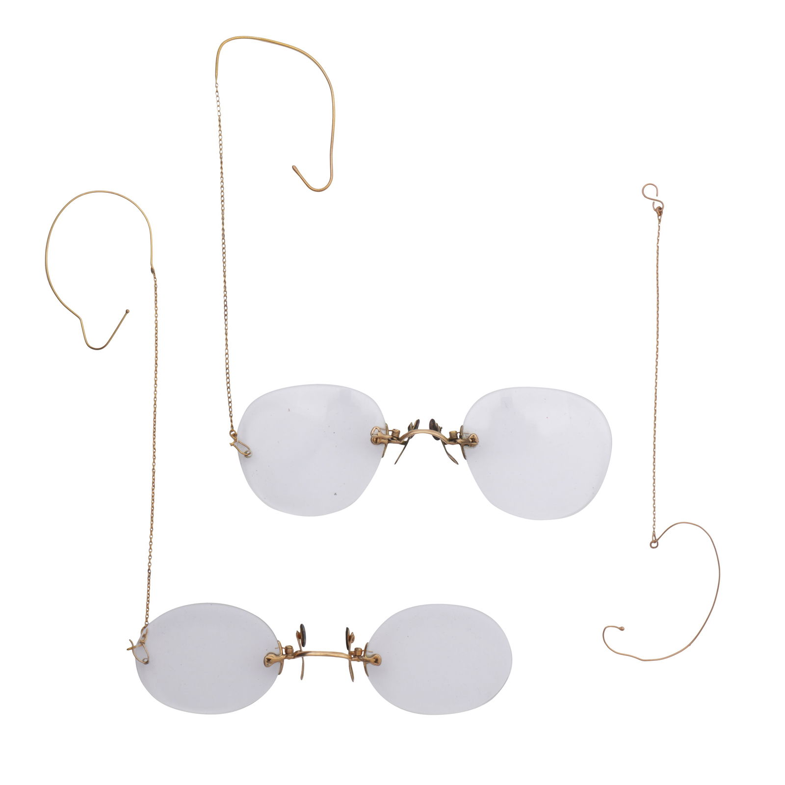Two pairs of frameless spectacles Yellow metal: Two pairs of frameless spectacles Yellow metal To include a pair of oval-shaped lenses, with two chain-link ear hooks, and another pair with a single ear hook, together with two cases (2) The items h
