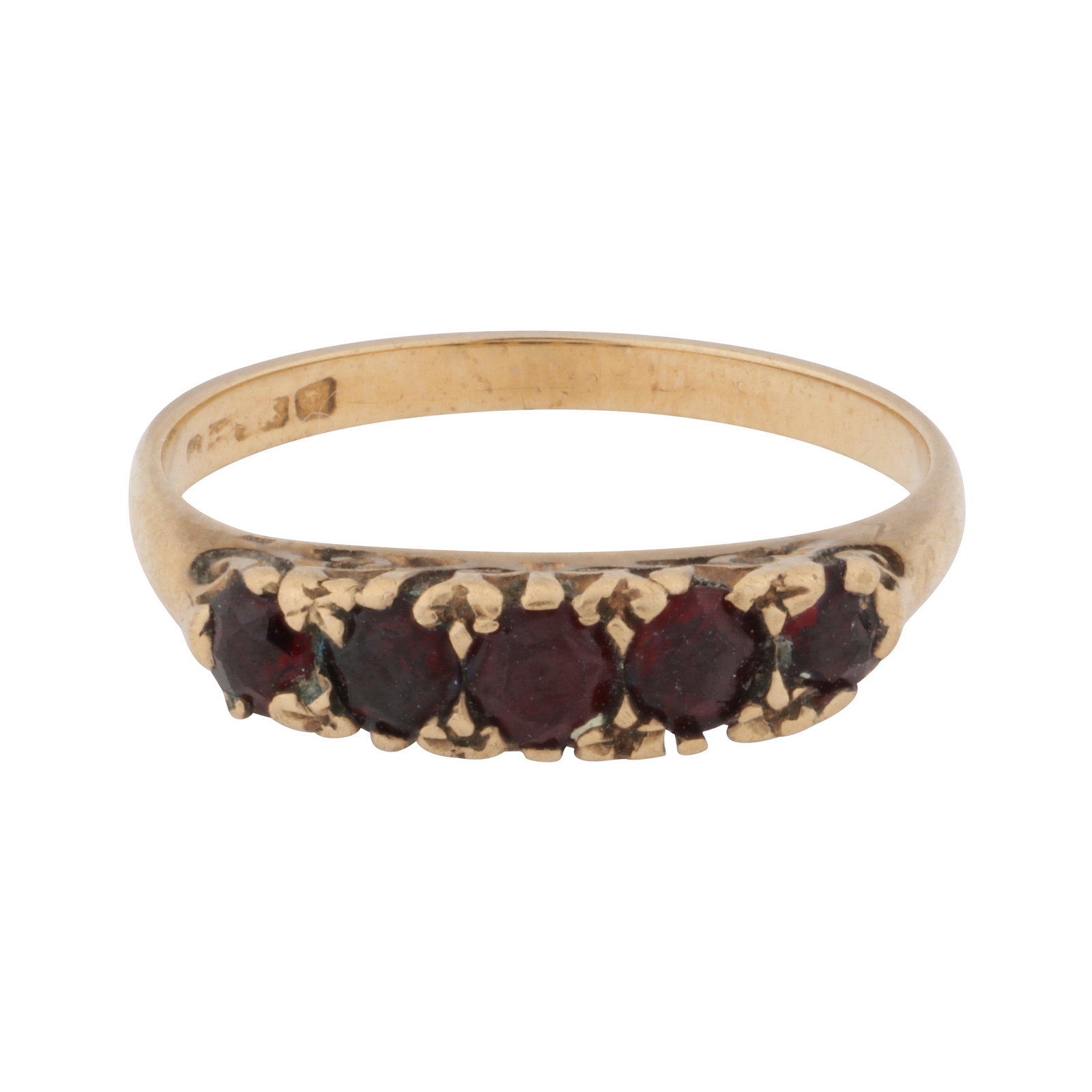 A garnet five stone ring 9ct yellow gold: A garnet five stone ring 9ct yellow gold Set with graduated circular-cut garnets, in a decorated gallery of scroll design, to a straight band, maker´s mark, partially visible UK hallmark, ring s
