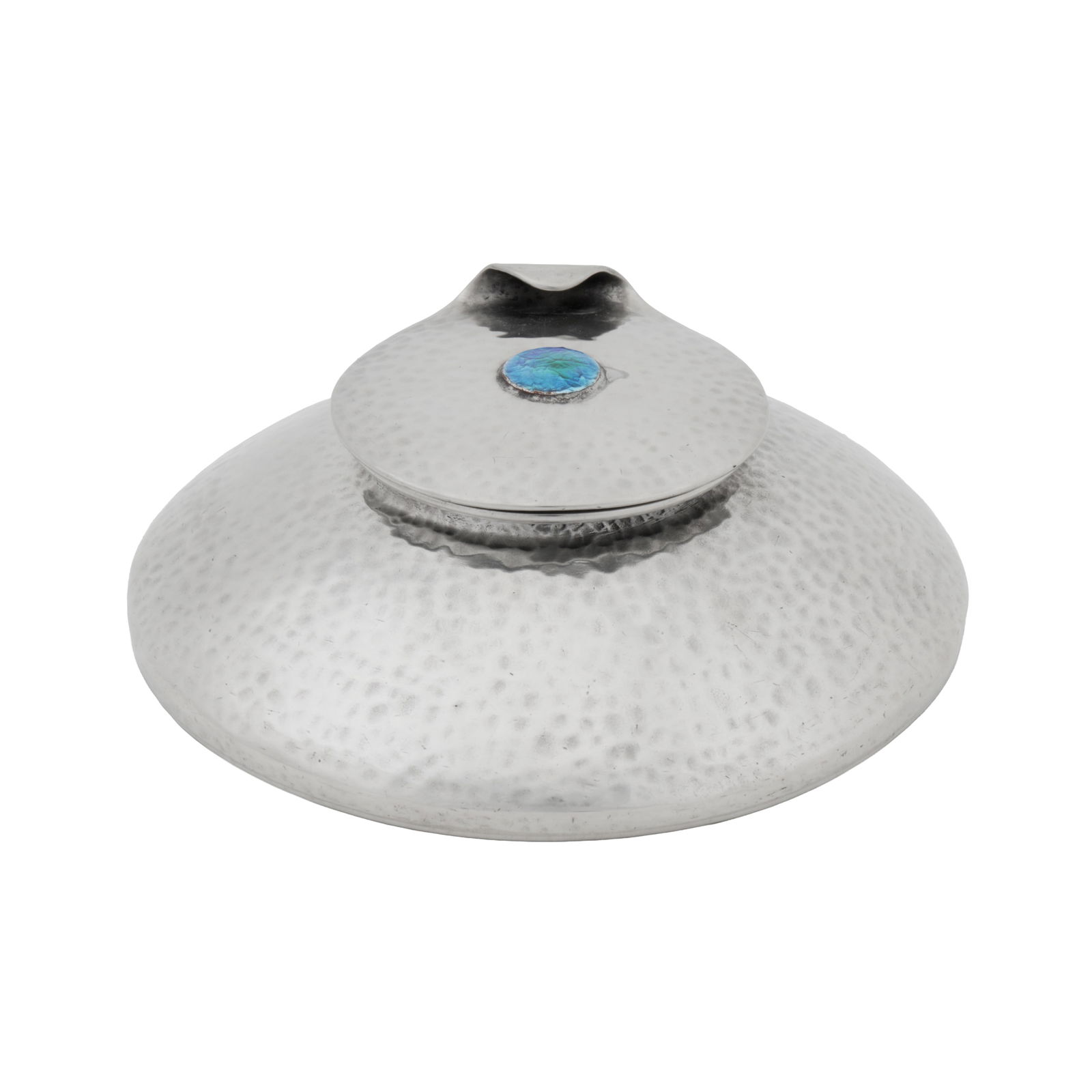Liberty and Co, British 'Tudric' inkwell with curled lip cover and blue enamel cabochon: Circa 1905 Hammered pewter Underside stamped 'TUDRIC', 'MADE IN ENGLAND', and Solkets mark 12.7cm diameter, 4.5cm high
