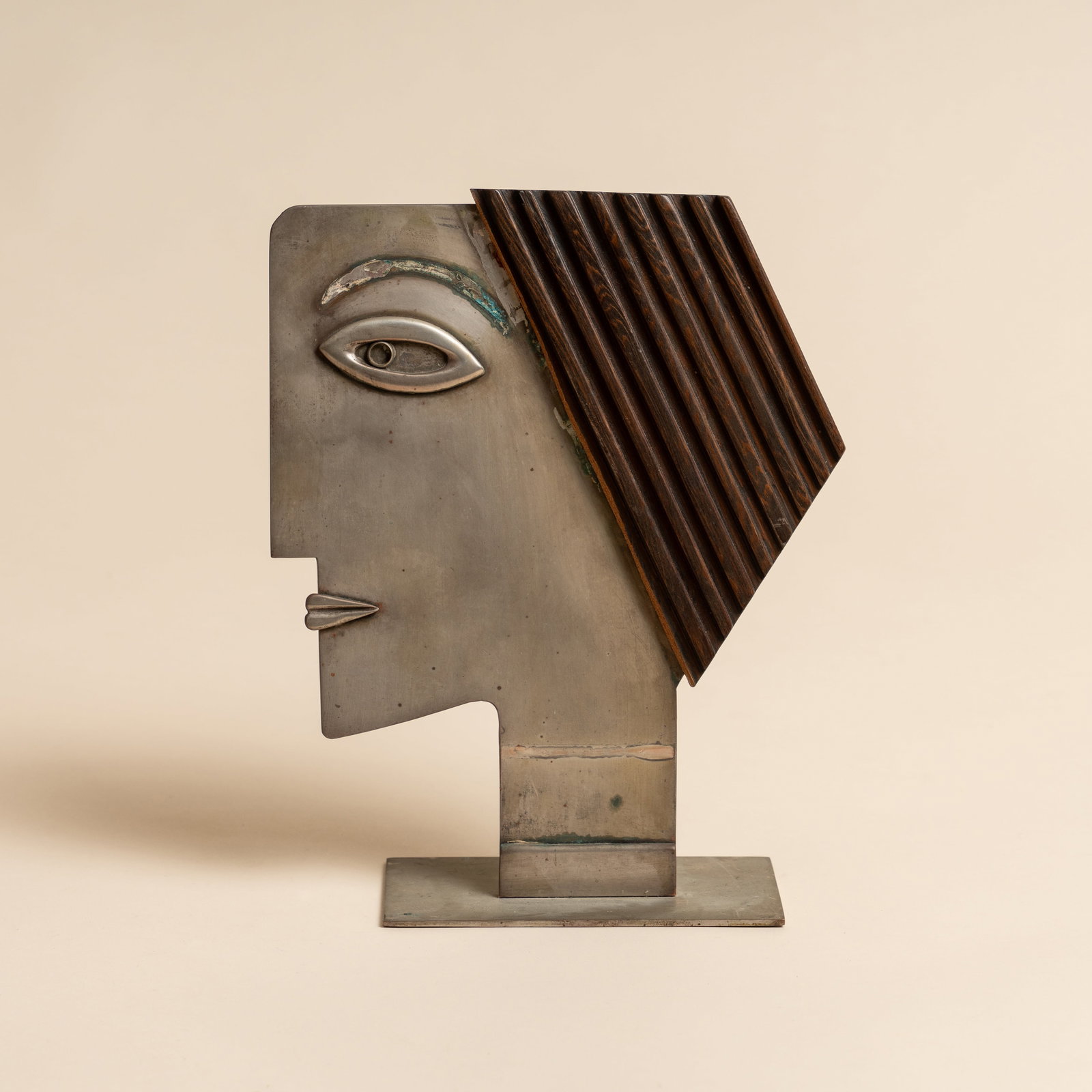 Franz Hagenauer (Austrian 1906-1986) for Wiener Werkstätte, Vienna 'Head in Profile' Female Bust: Circa 1935 Nickel-plated brass, wood Stamped 'HAGENAUER. WIEN FRANZ' along with Werkstätte Hagenauer cipher to underside 24cm high Provenance:The collection of Mo Amelia Teitelbaum Mo is a collector,