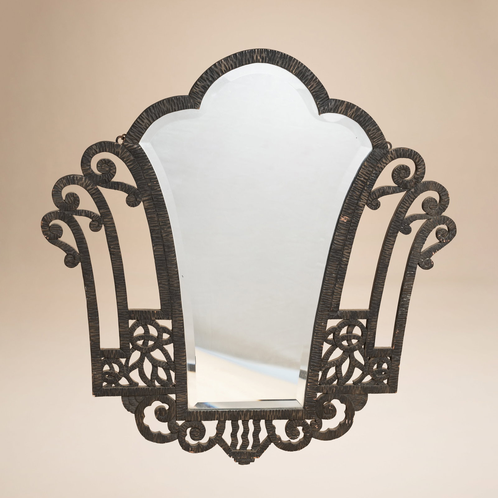 In the manner of Paul Kiss (Hungarian 1895-1962) Art Deco wall mirror: Circa 1930s to 1940s Stained oak, mirrored plate 59cm high x 70cm wide Provenance:From a private collection, London