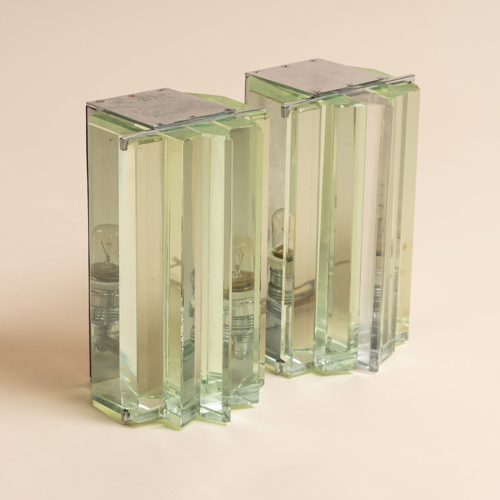 Maison Desny, Paris Pair of wall sconces: Circa 1930s Nickel, clear glass Stamped 'DESNY PARIS MADE IN FRANCE DEPOSE' 23cm high x 13cm wide x 13cm deep Provenance:From a private collection, London