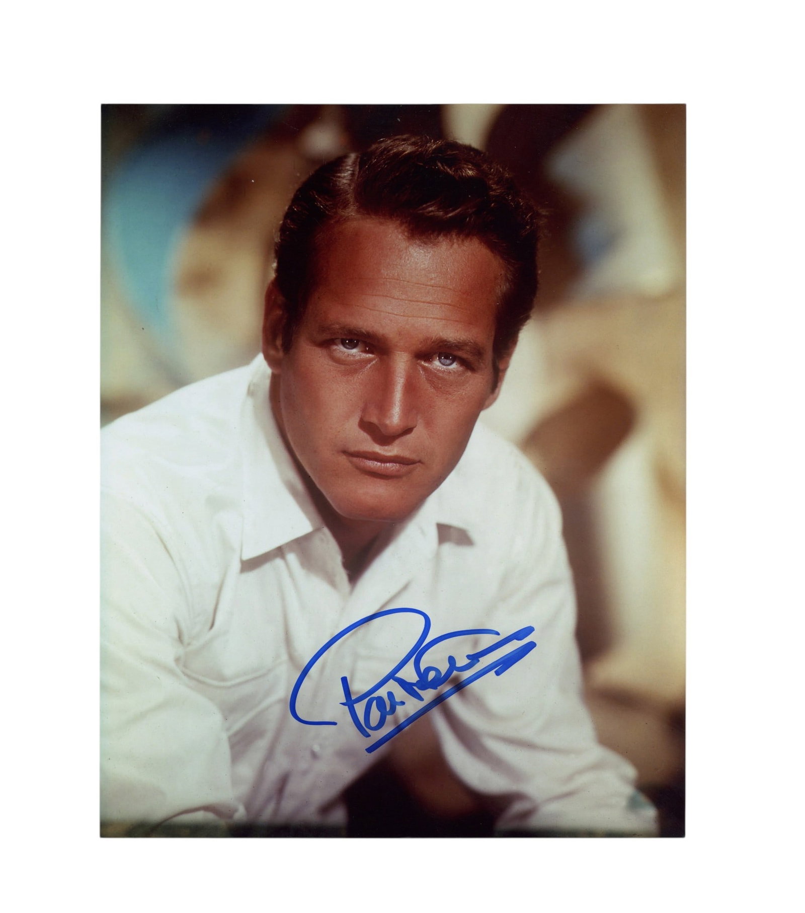 Newman (Paul) Signed photograph: Newman (Paul) Signed photograph Colour glossy photograph of Newman staring into the camera, signed in blue felt tip across a lower portion of the image. Dimensions:10 x 8"/ 25.5. x 20.5cm Provenance: