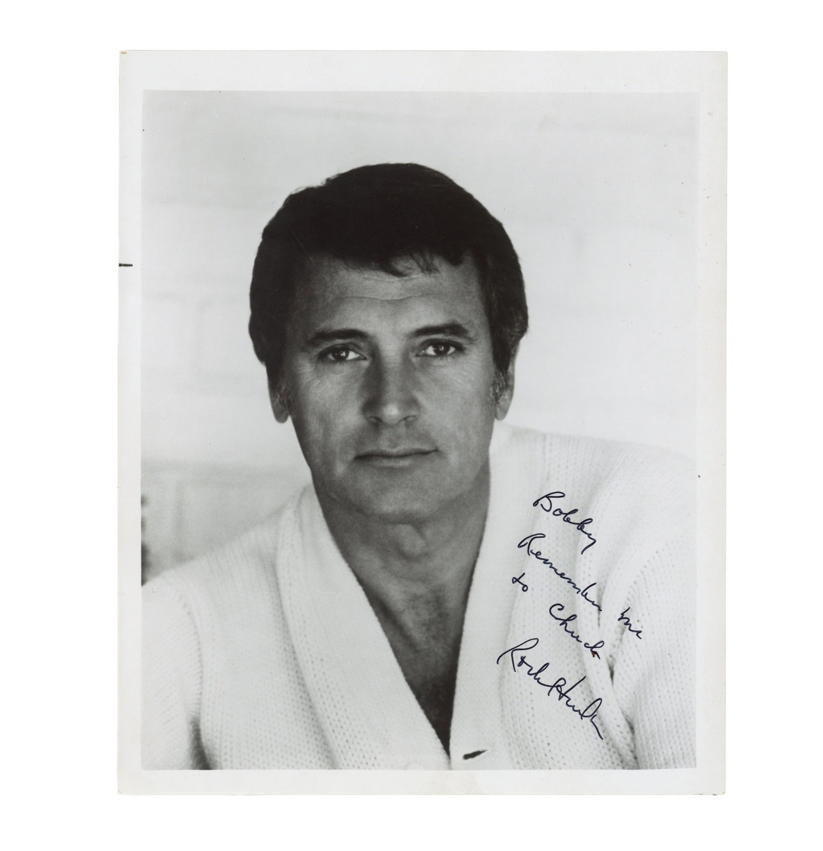 Hudson (Rock) Signed photograph: Hudson (Rock) Signed photograph Glossy black and white photograph of Hudson in a head and shoulders pose, signed and inscribed in black felt tip "Bobby, Remember me to Chuck, Rock Hudson", minor