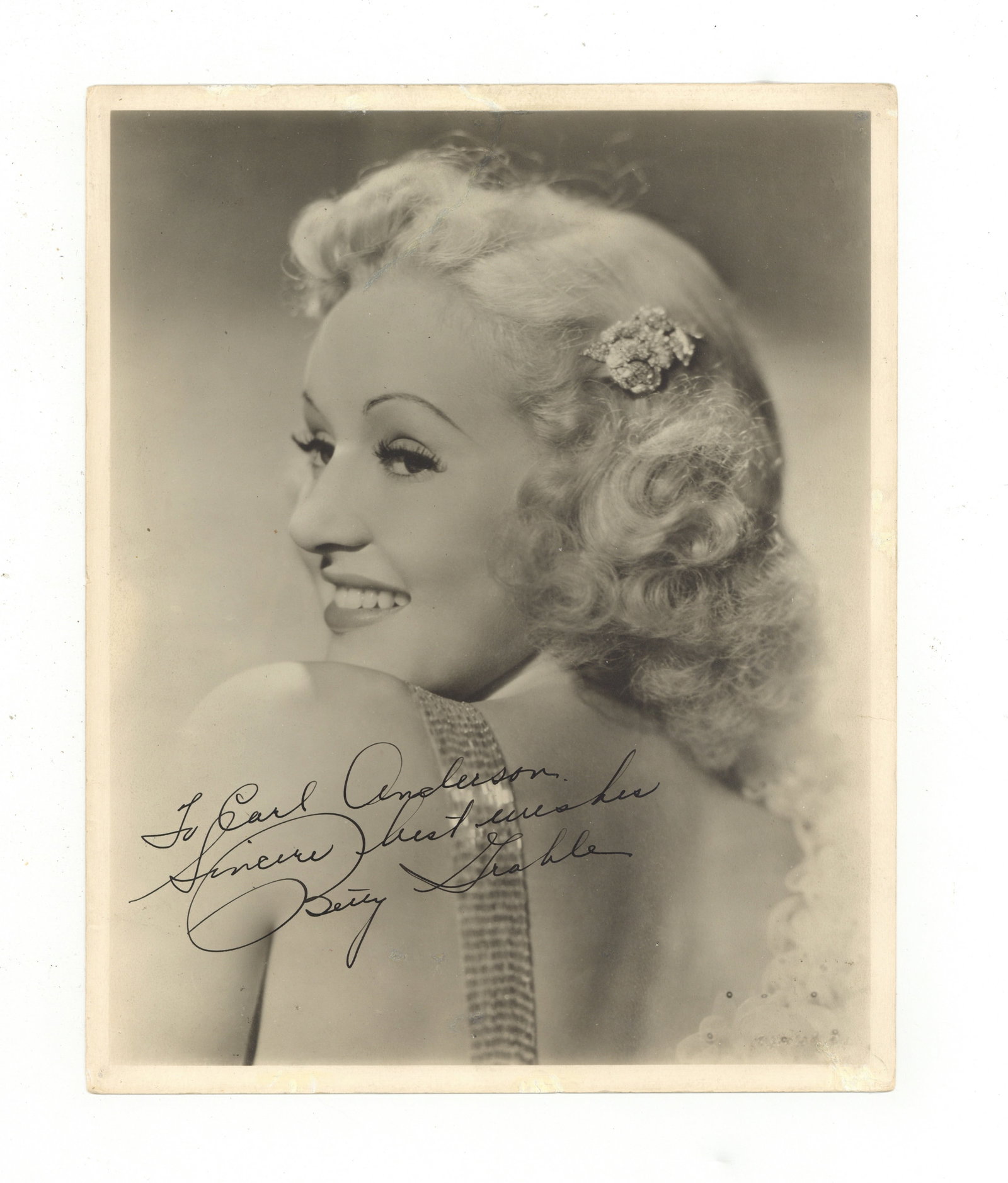 Grable (Betty) Signed photograph: Grable (Betty) Signed photograph The image featuring Betty Grable in a head and shoulders, smiling pose, signed and inscribed "To Carl Anderson, Sincere best wishes, Betty Grable". Dimensions:10 x