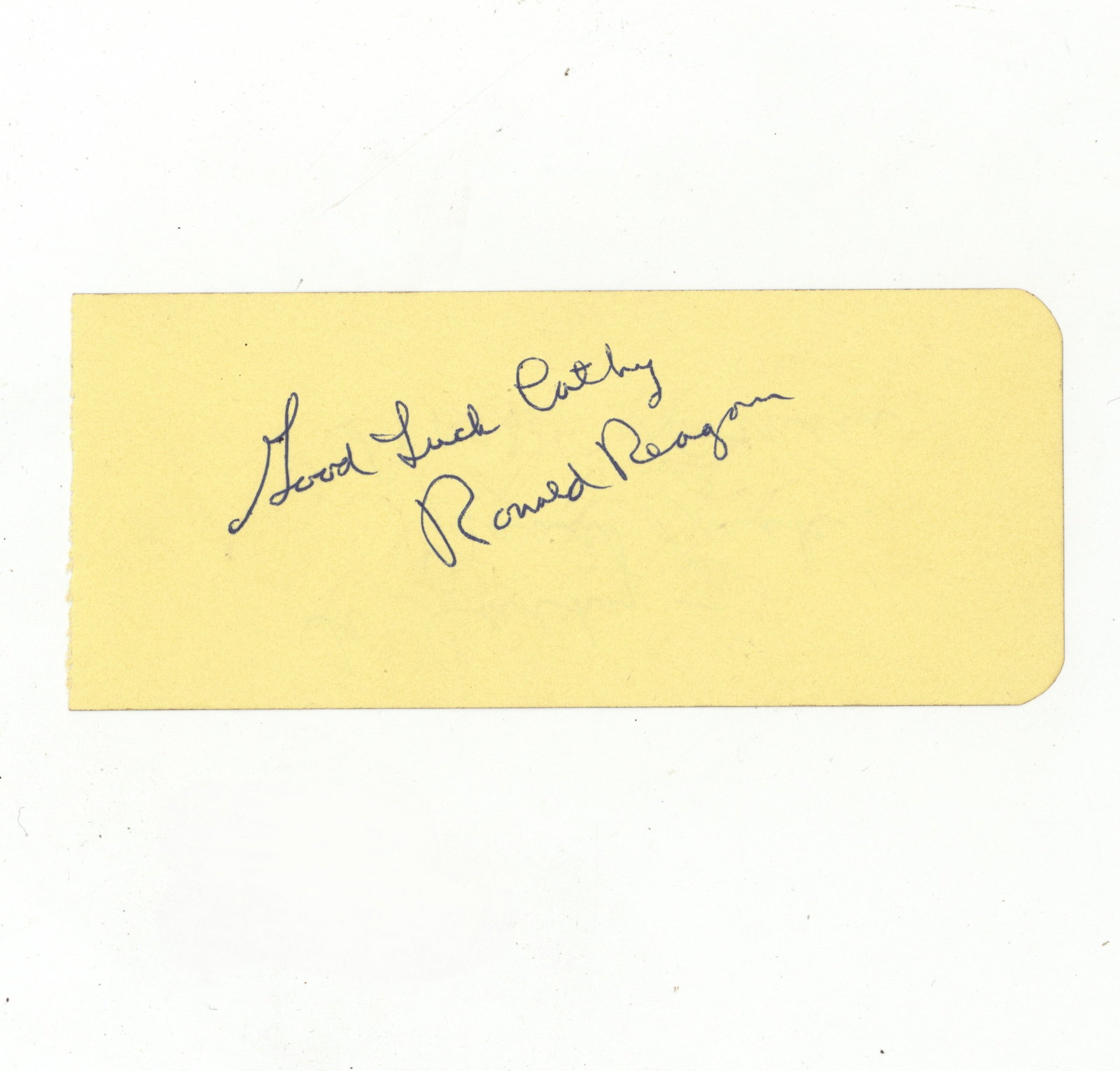 Reagan (Ronald) Ink signature: Reagan (Ronald) Ink signature Blue ballpoint ink signature and inscription ("Good luck Cathy, Ronald Reagan") on loose album page, signature of Dottie Lamour on the verso. Dimensions:2.25 x 5.3"/5.5