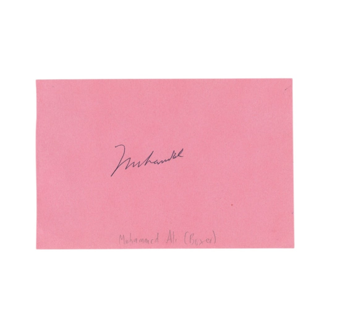 Ali (Muhammad) Signed card: Ali (Muhammad) Signed card Black ballpoint ink signature by the boxing champion on pink album page, name of signer annotated by collector in pencil. Dimensions:3.5 x 5.25"/ 9 x 13.5cm