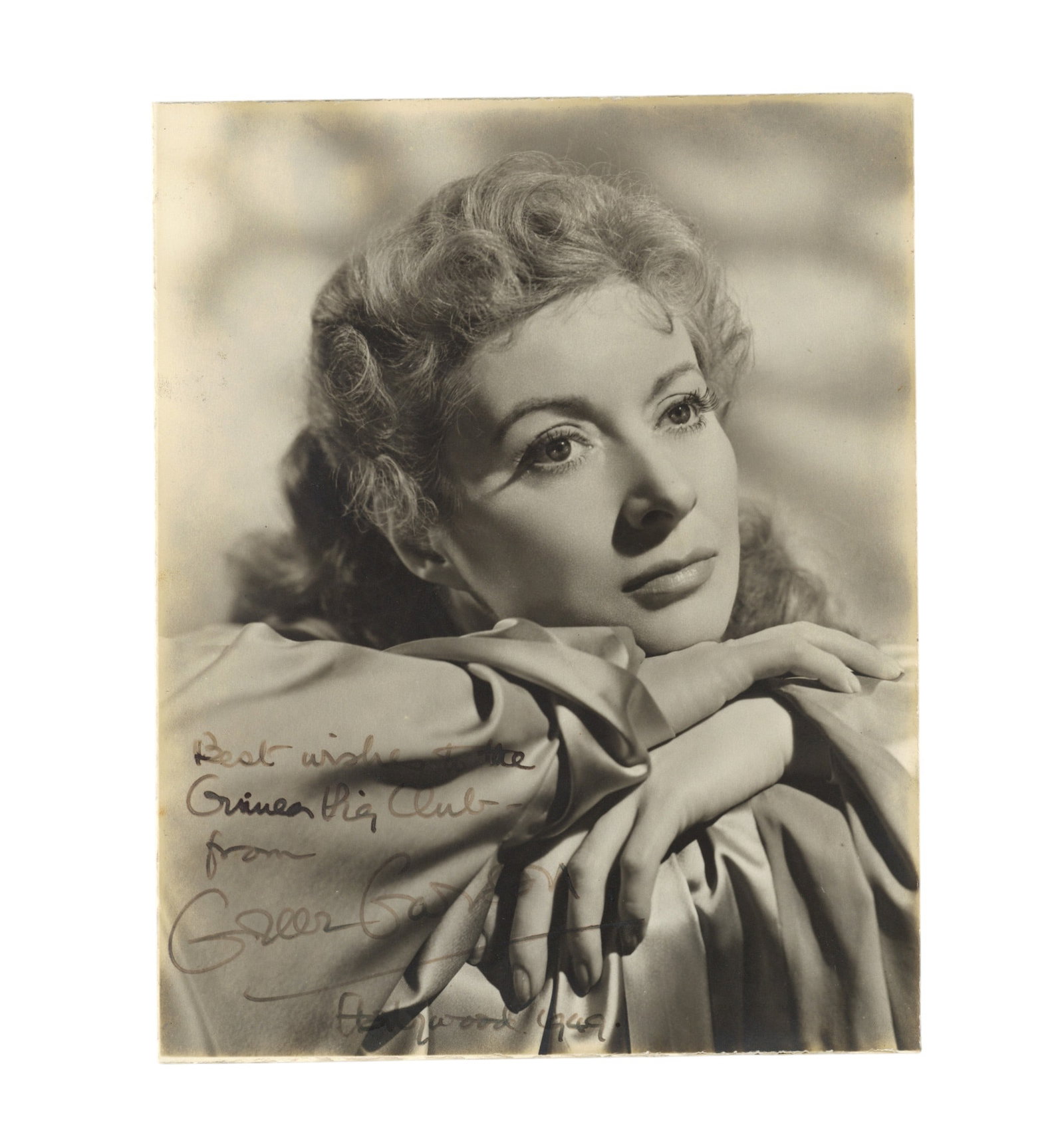 Garson (Greer) Signed photograph: Garson (Greer) Signed photograph Vintage black and white photograph of the actress in a dreamy pose, signed and inscribed on the lft-hand side "Best wishes to the Guinea Pig Club, from Greer Garson,