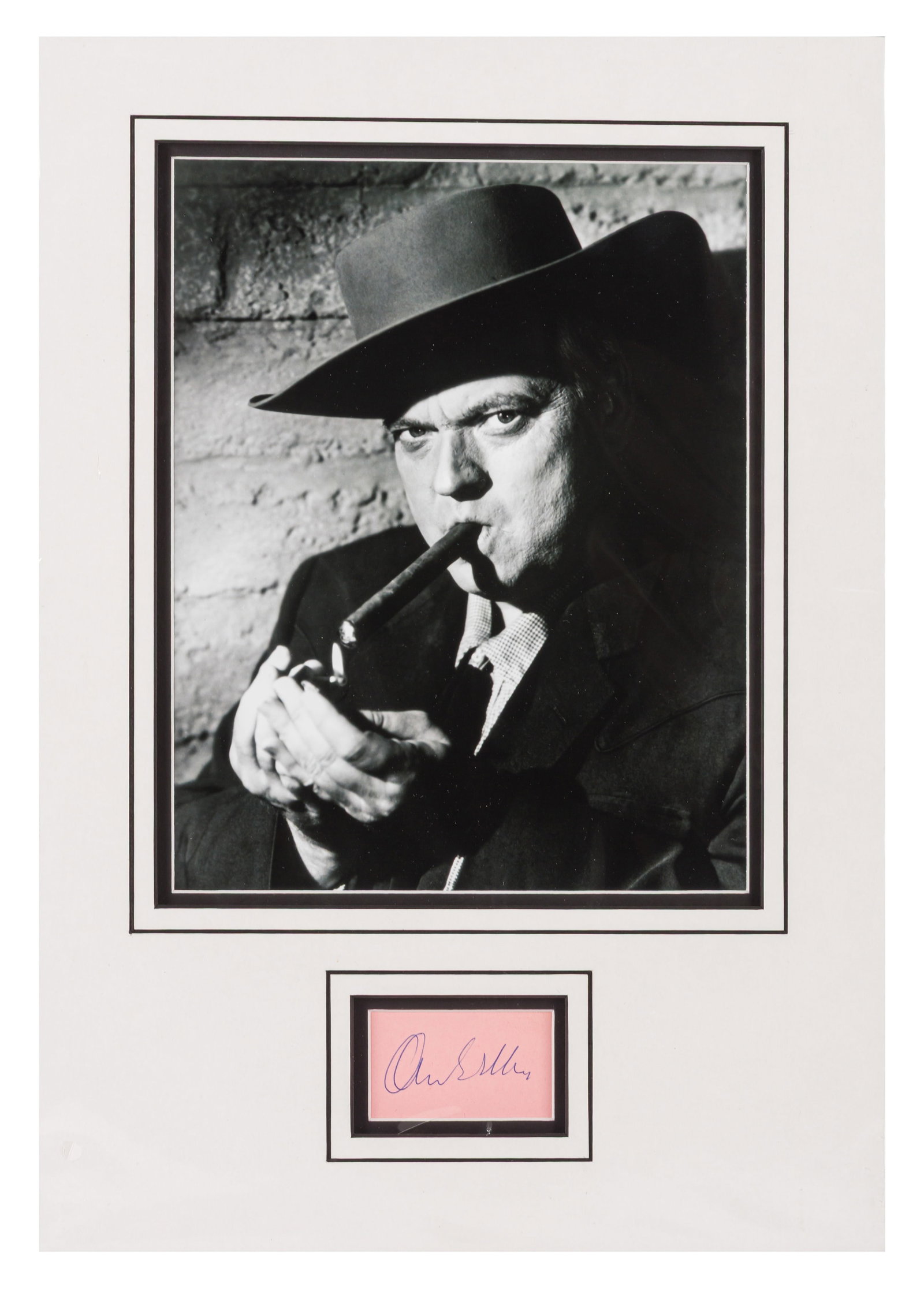 Welles (Orson) Ink signature: Welles (Orson) Ink signature Blue ballpoint ink signature on pink card, attractively mounted for display with a photograph of the movie star. ***Accompanied by a certificate from Autographs.co.uk