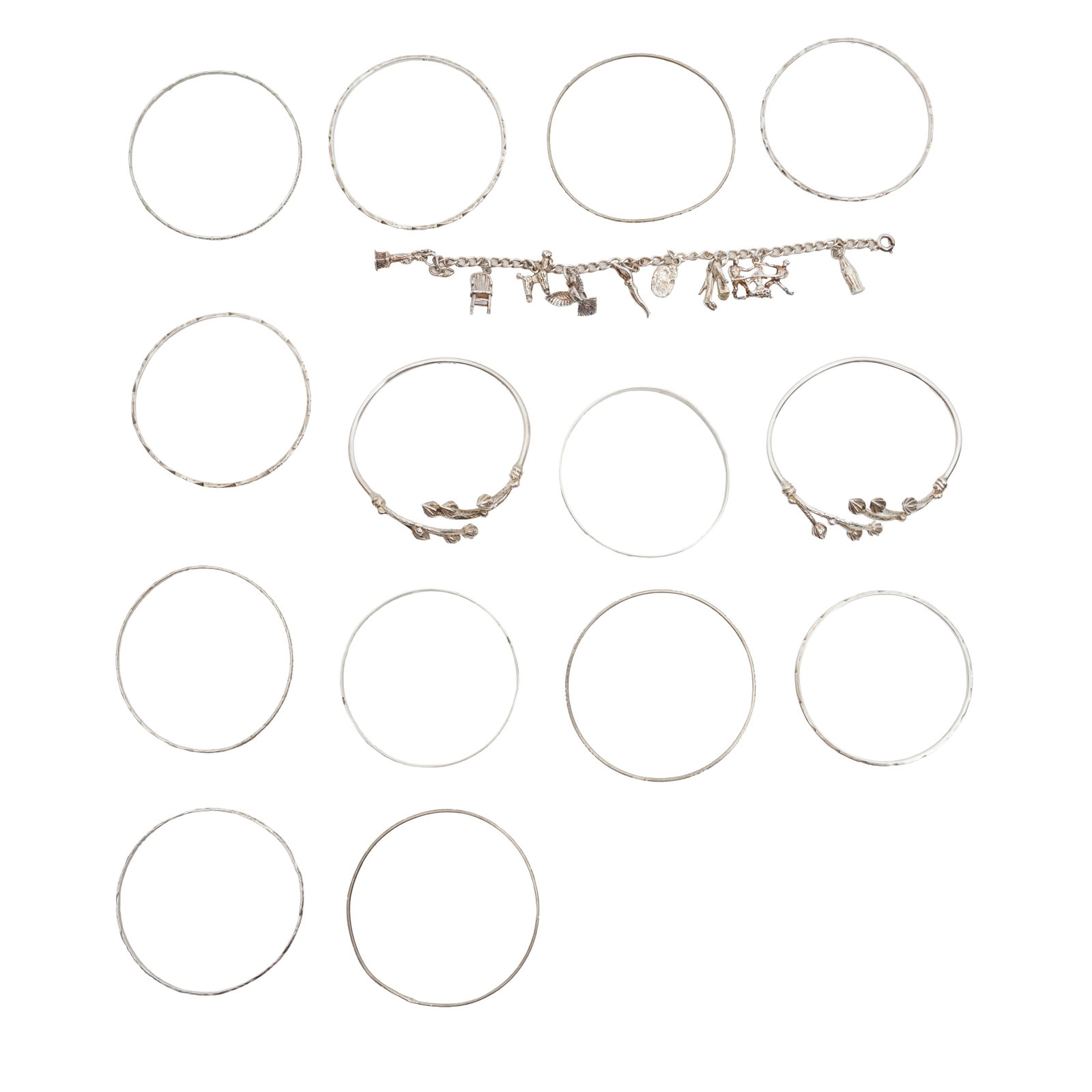 A group of bracelets White metal: A group of bracelets White metal Including 14 bangles and one charm bracelet suspending 8 charms, some unmarked, some marked sterling, various sizes (15)