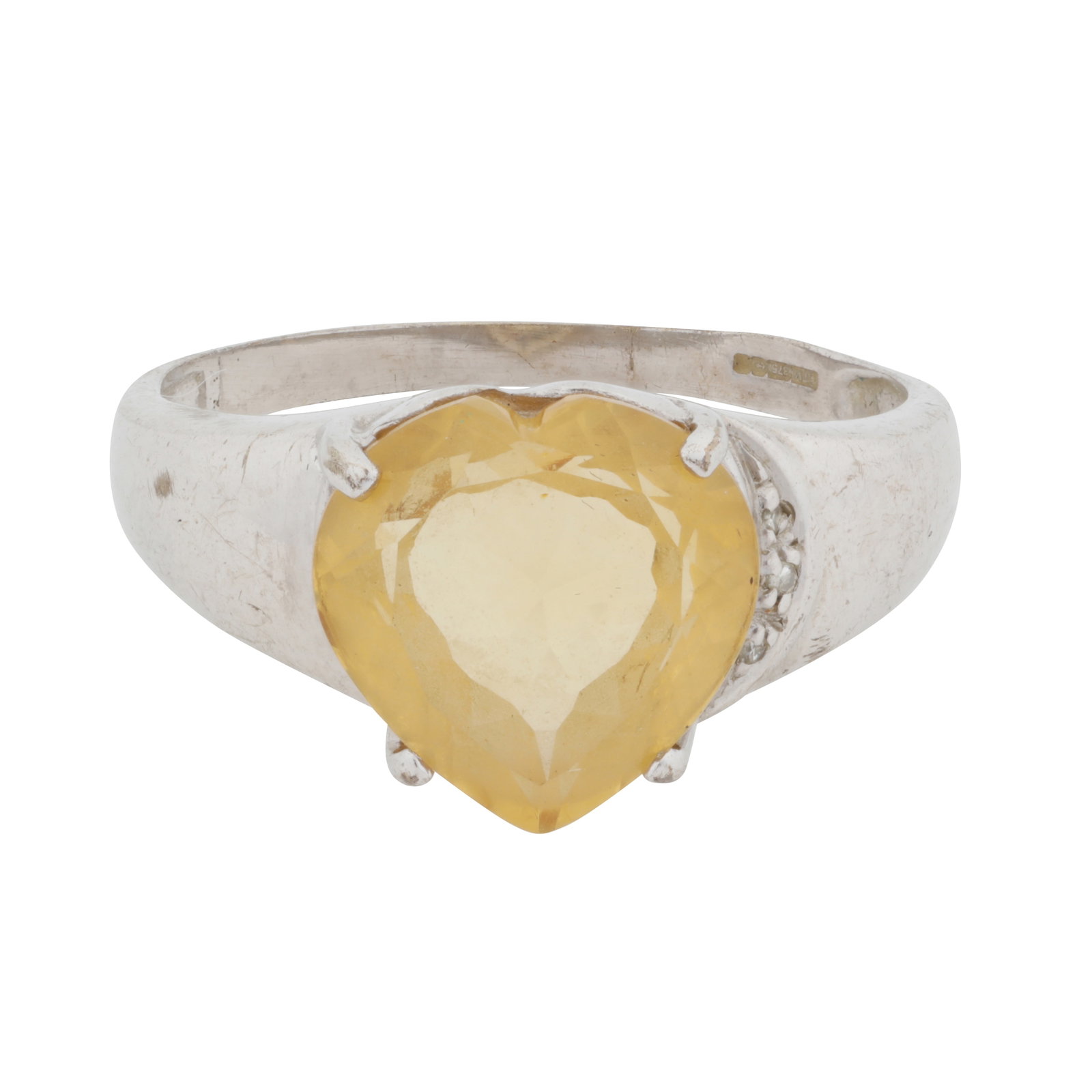 A citrine and diamond heart ring 9ct white gold: A citrine and diamond heart ring 9ct white gold The claw-set heart-shaped citrine, accented by single-cut diamonds, to a tapered band, maker's mark, UK hallmark, size X