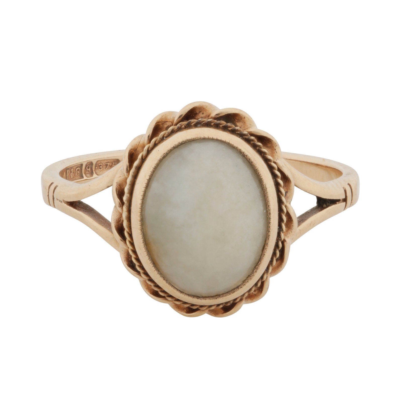A white jadeite single stone ring 9ct yellow gold: A white jadeite single stone ring 9ct yellow gold Centrally set with an oval-cut white jadeite cabochon, to rope-twist borders and bifurcated shoulders, maker's mark, UK hallmark, size N