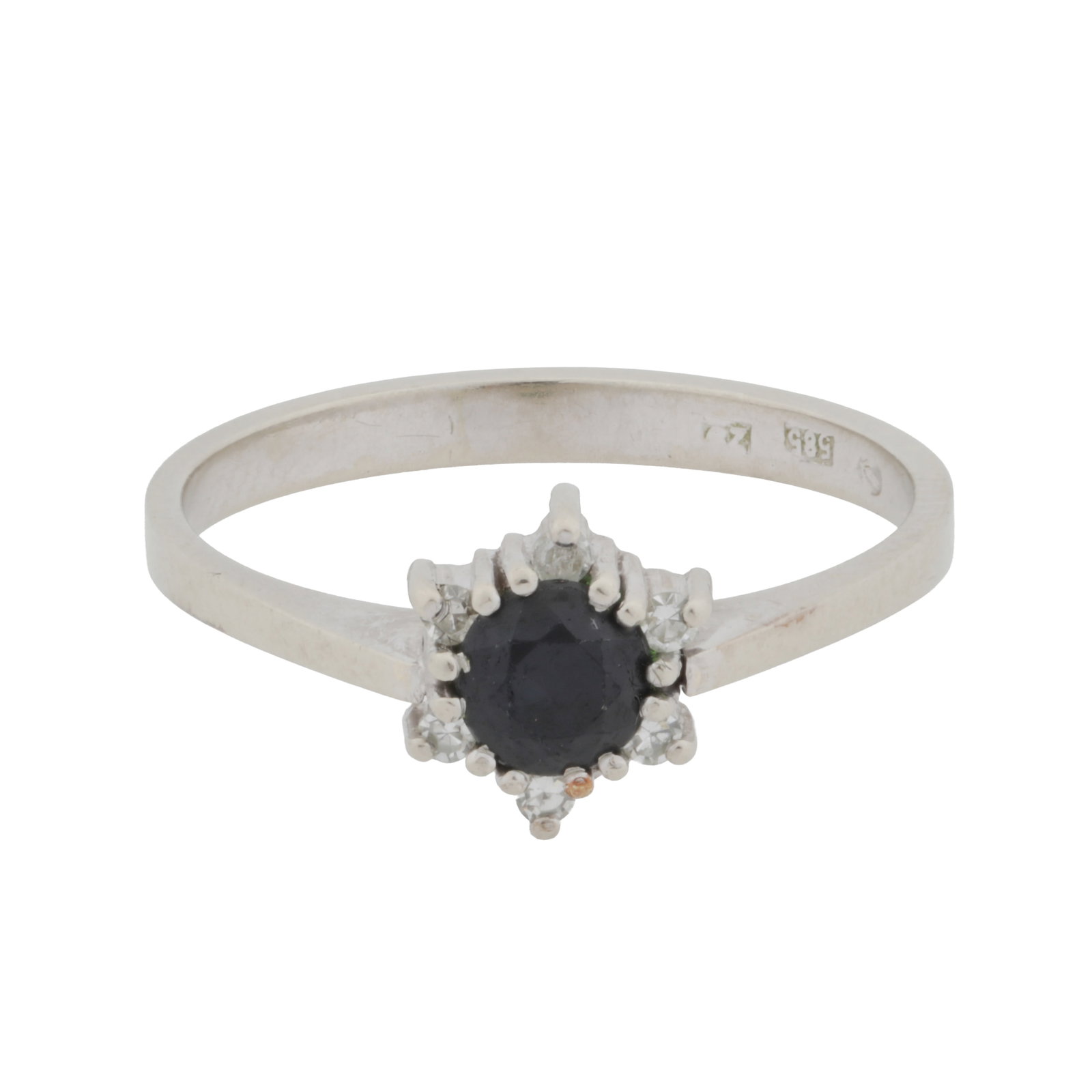 A sapphire and white sapphire ring White metal: A sapphire and white sapphire ring White metal Of cluster design, set with a circular-cut blue sapphire within a surround of white sapphires, maker's mark CZ, stamped 585, ring size R