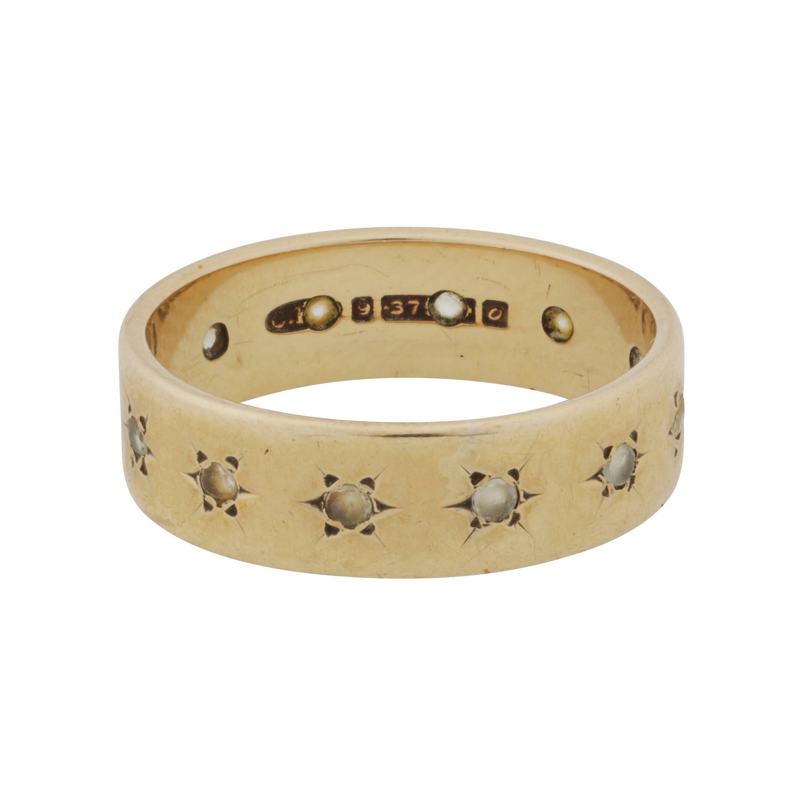 A paste full eternity ring 9ct yellow gold: A paste full eternity ring 9ct yellow gold Star-set with circular-cut white pastes, maker's mark, UK hallmark, size M